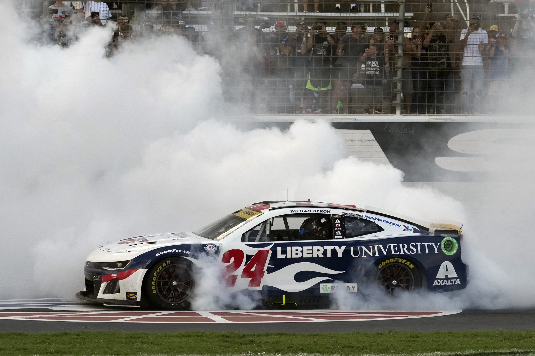 William Byron (24) burns his tires after winning the NASCAR Cup Series auto race at Texas Motor Speedway in Fort Worth, Texas, Sunday, Sept. 24, 2023. (AP Photo/LM Otero)