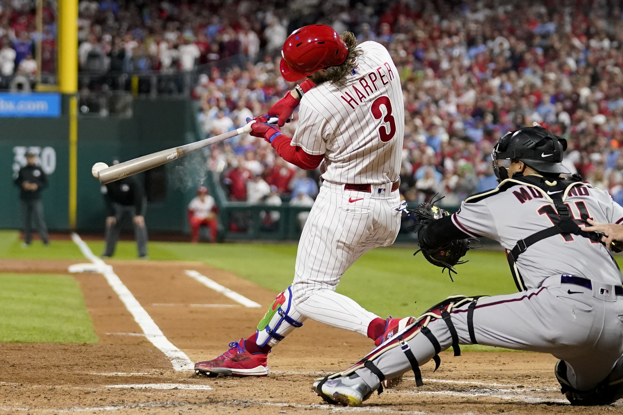 Philadelphia Phillies' Bryce Harper hits a RBI-single against the Arizona Diamondbacks during the third inning in Game 1