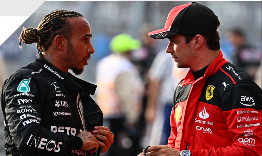 Lewis Hamilton and Charles Leclerc speak on the track.
