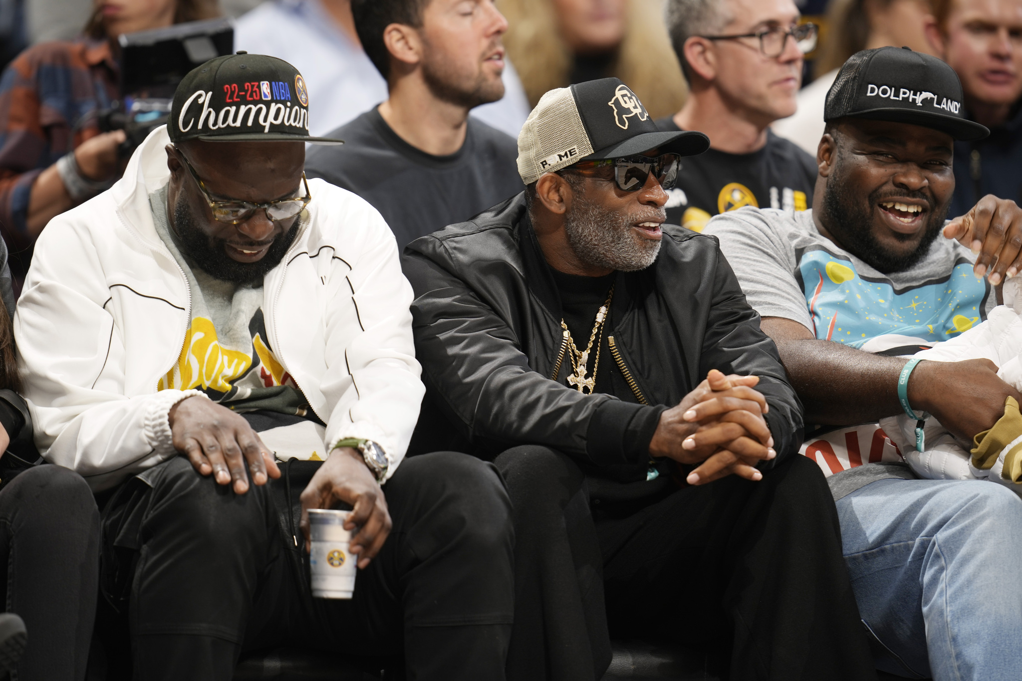 Colorado football coach Deion Sanders (center) was courtside to watch the Nuggets take on the Lakers.