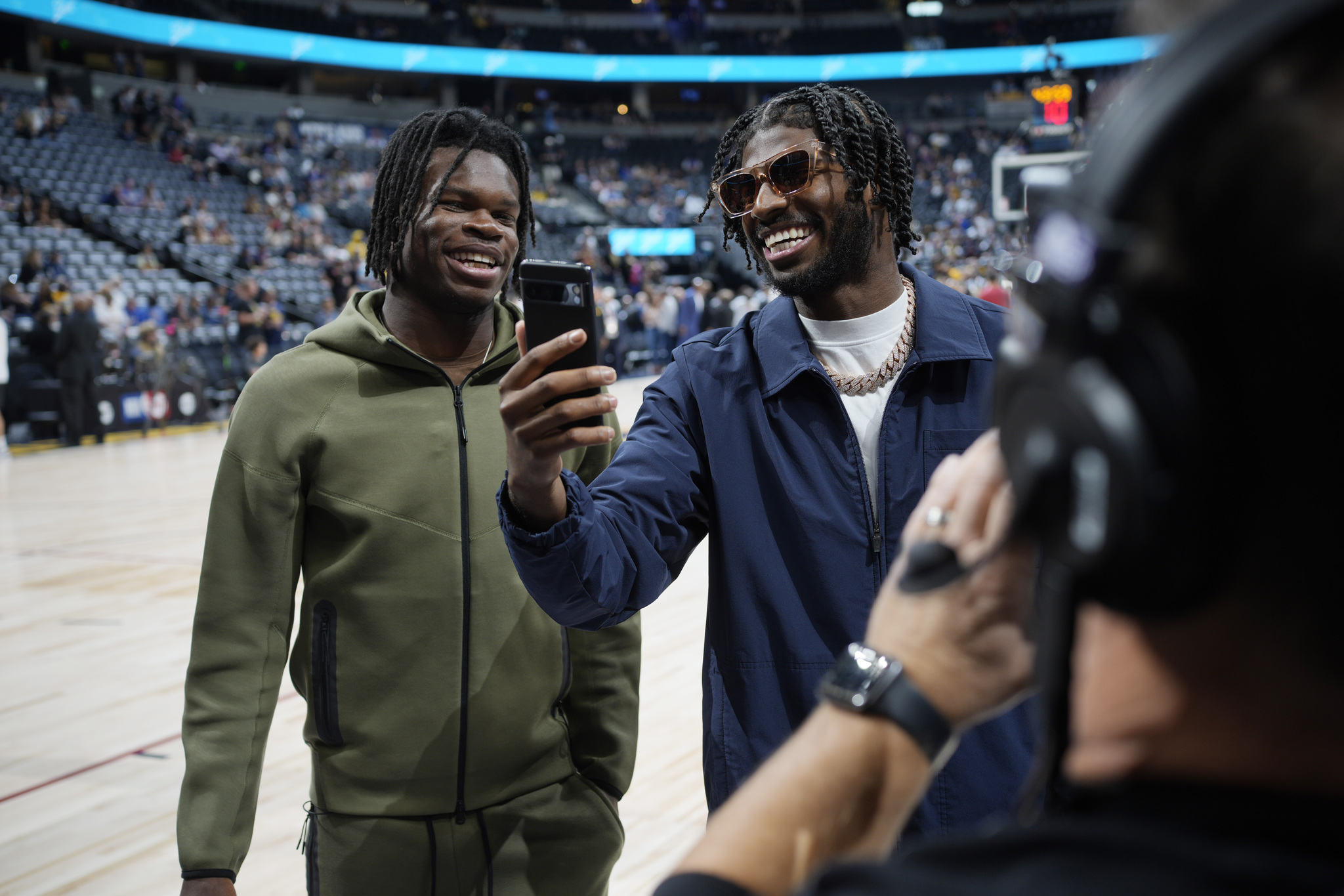 WR and CB phenom Travis Hunter (left) and QB Shedeur Sanders were in Denver for the Nuggets opening night win.