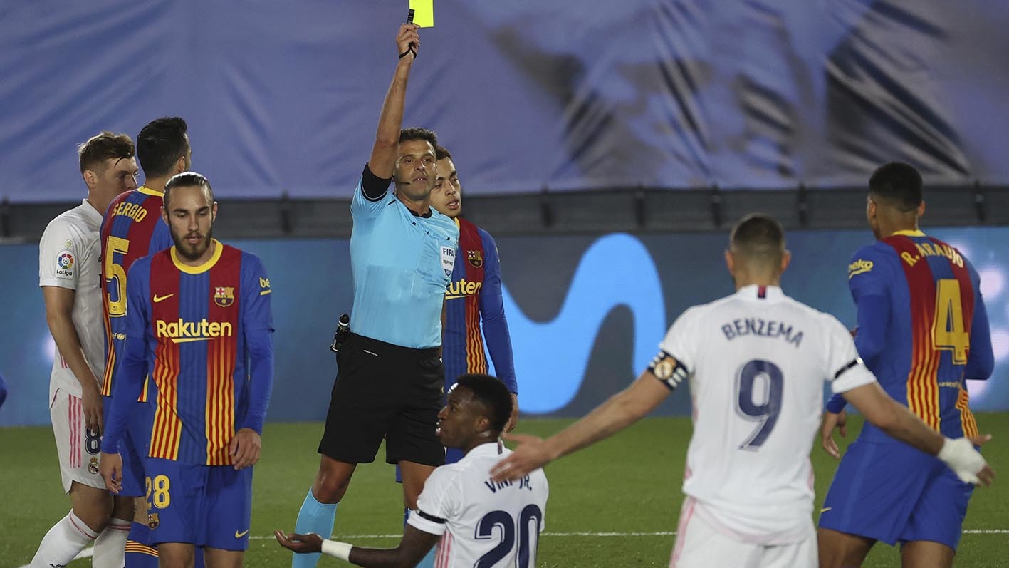 Gil Manzano saca una tarjeta durante un Madrid-Barcelona de 2021.