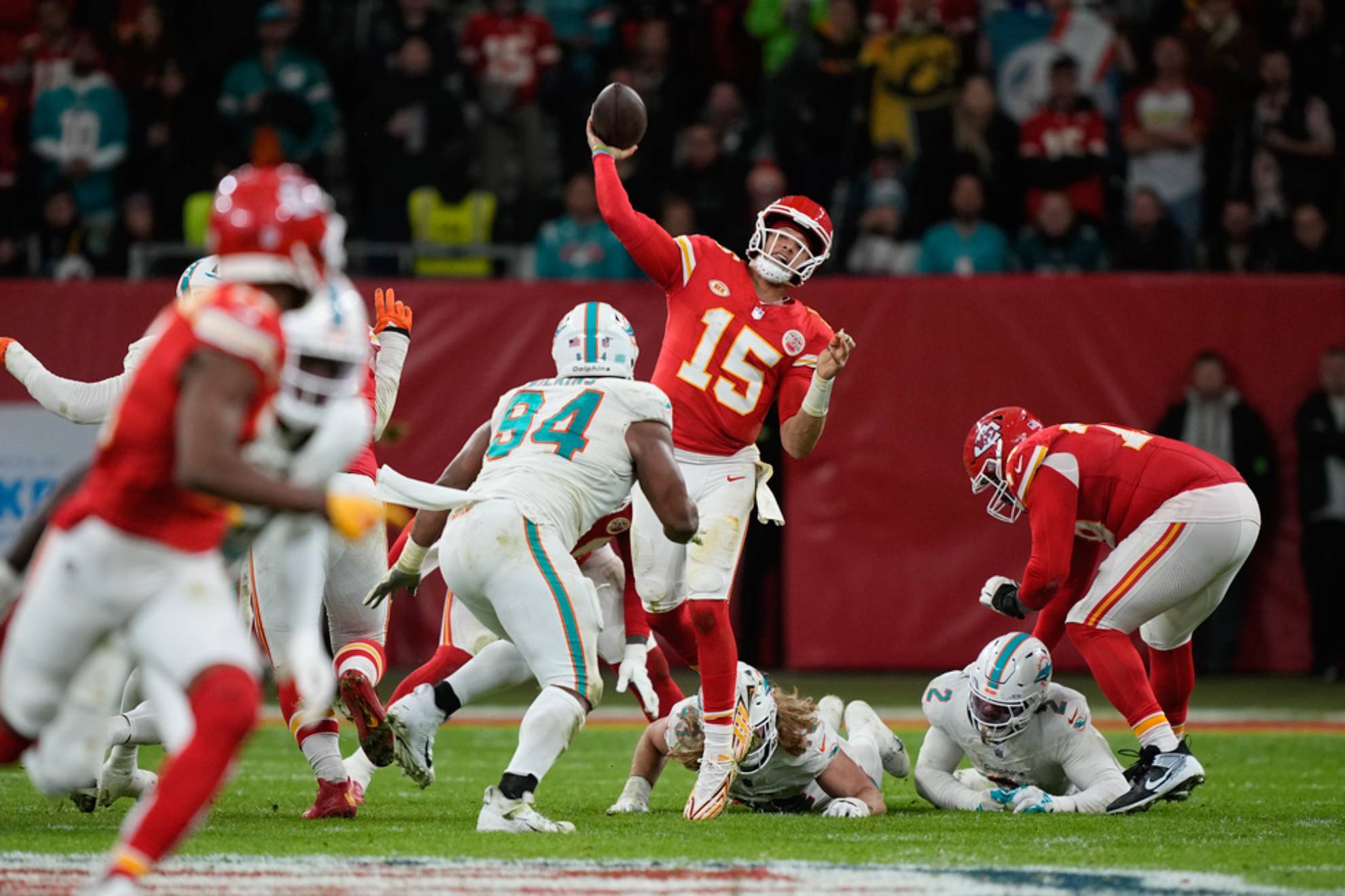 Patrick Mahomes (15) throws during the second half of an NFL football game against the Miami Dolphins /