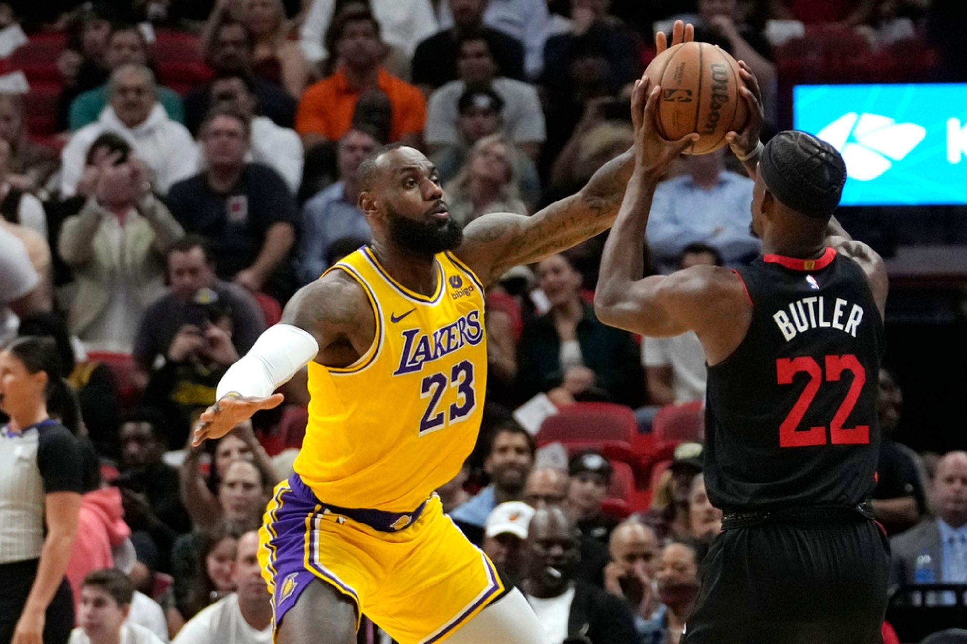 Los Angeles Lakers forward LeBron James (23) defends Miami Heat forward Jimmy Butler (22) during the first half of an NBA basketball game