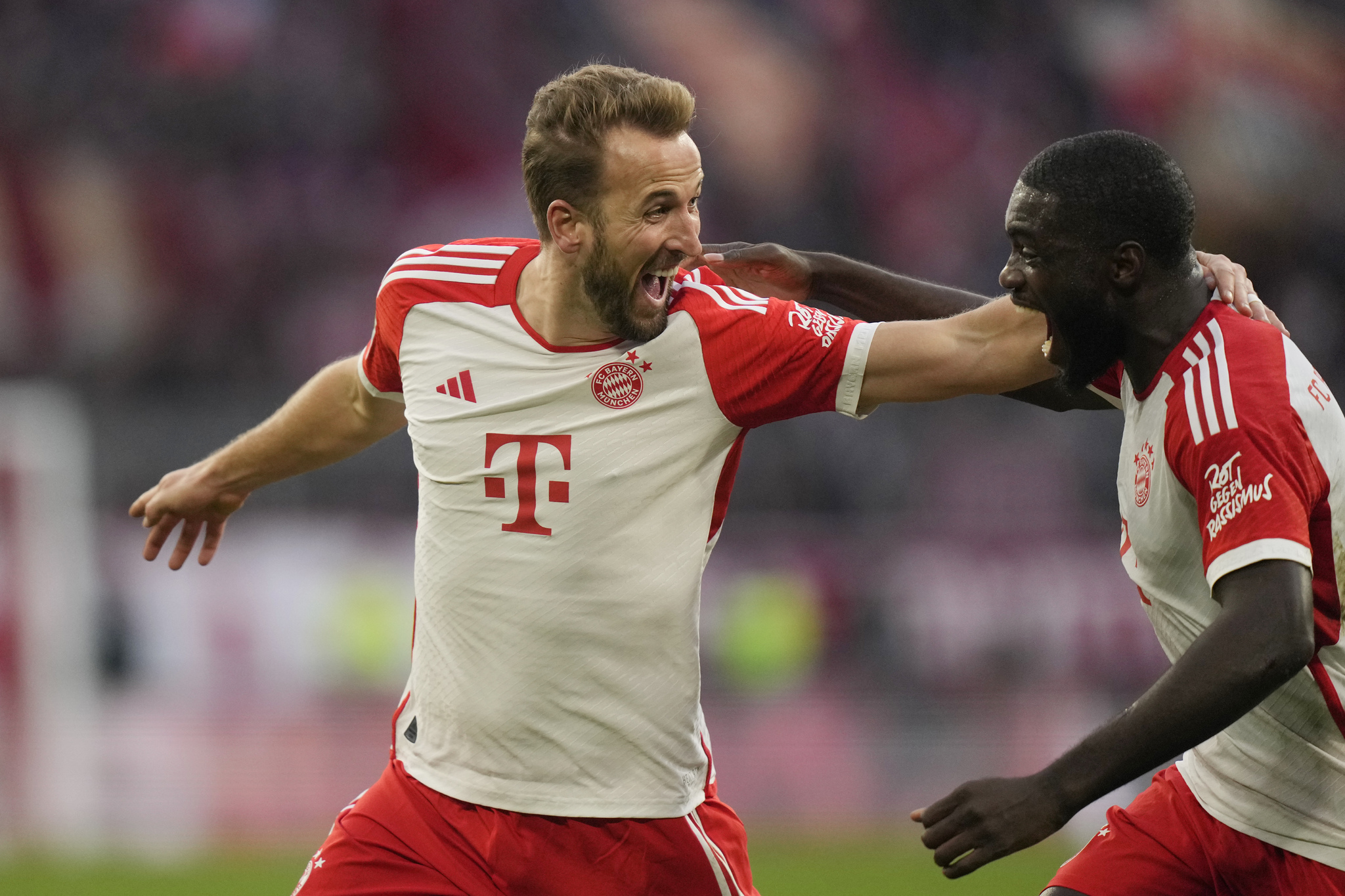 Bayern's Harry Kane, left, celebrates scoring