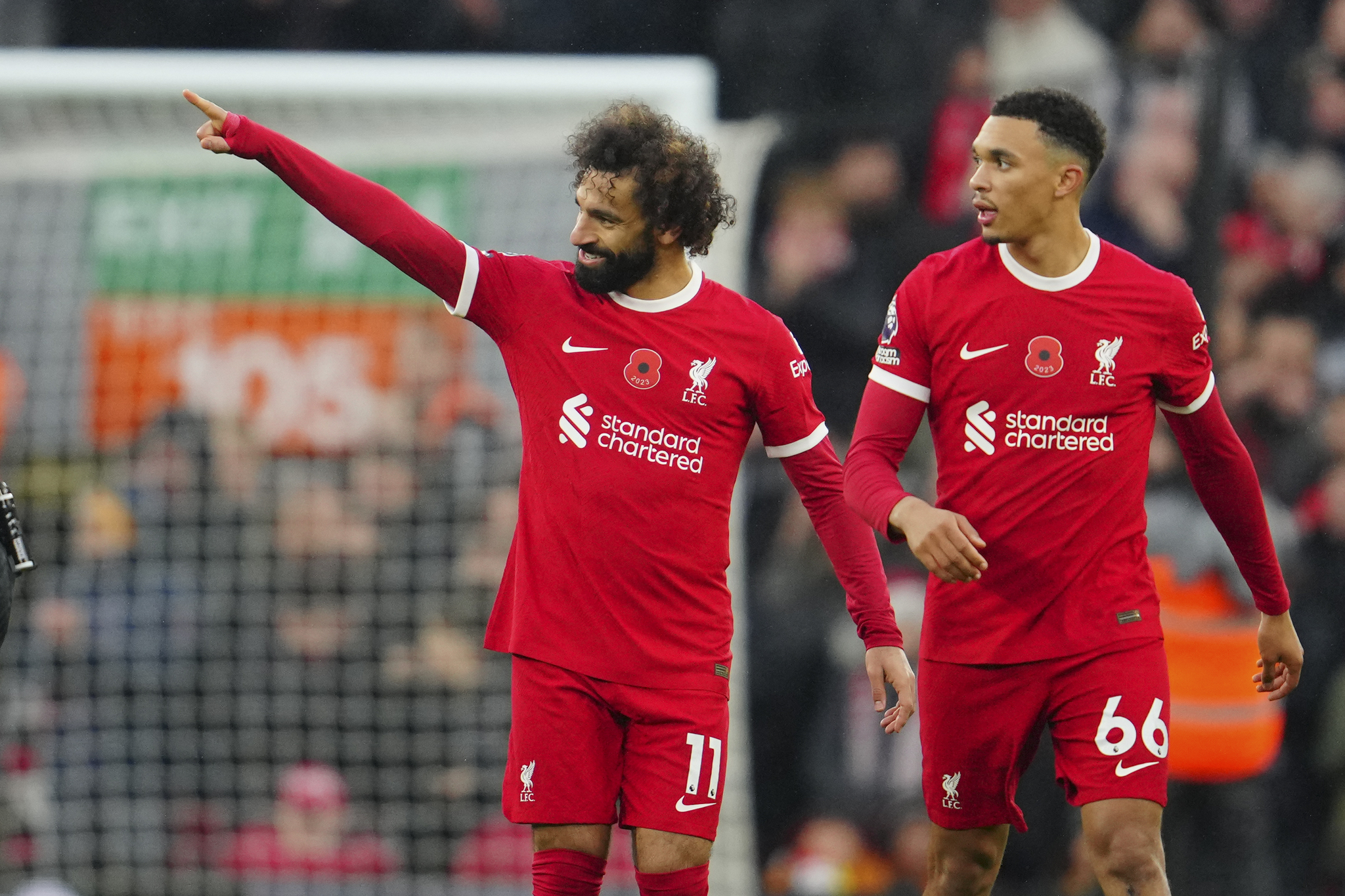 Liverpools Mohamed Salah, left, celebrates with teammate Trent Alexander-Arnold