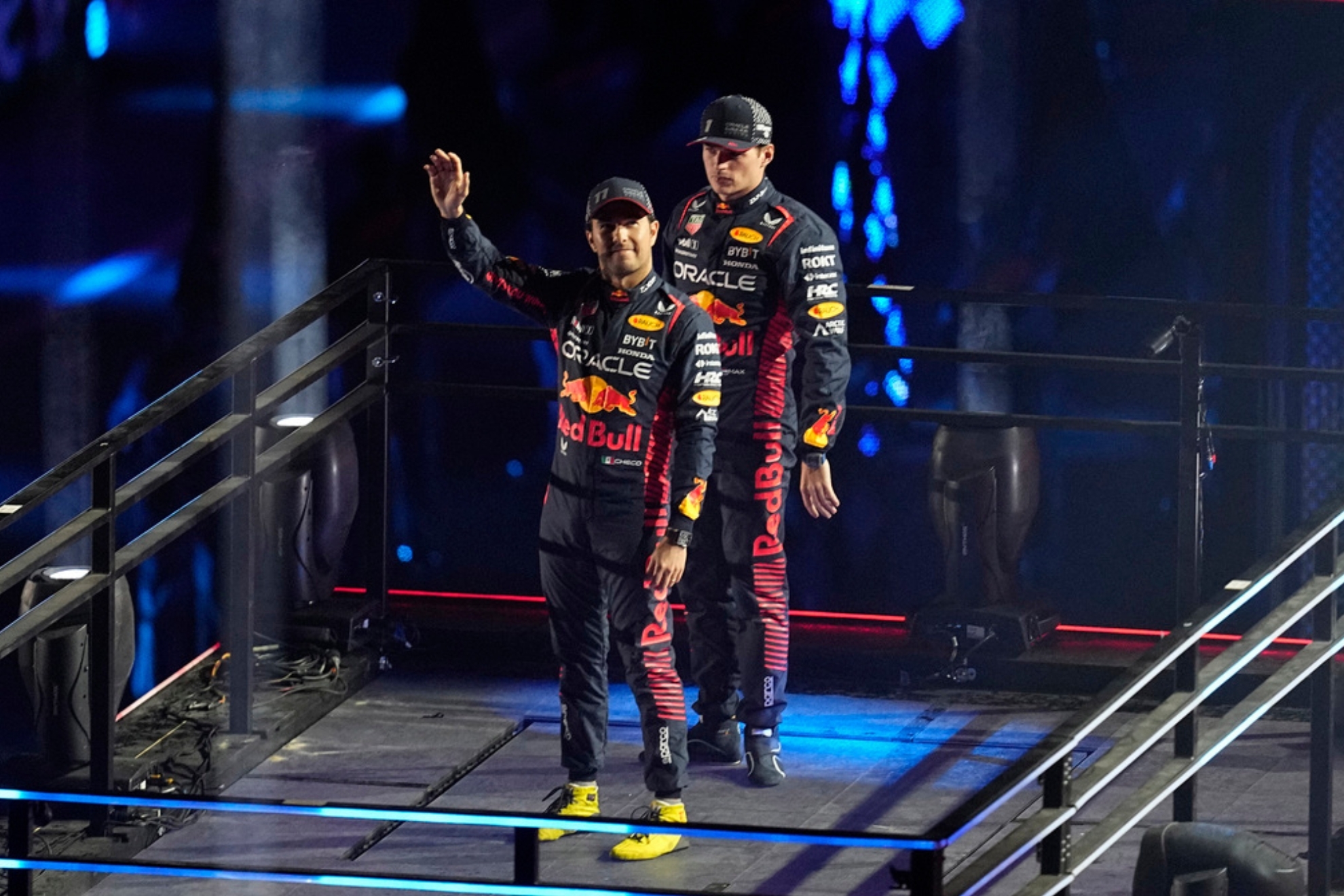 Red Bull driver Sergio Perez, of Mexico, left, and Red Bull driver Max Verstappen, of the Netherlands, motion during an opening ceremony for the Formula One Las Vegas Grand Prix auto race