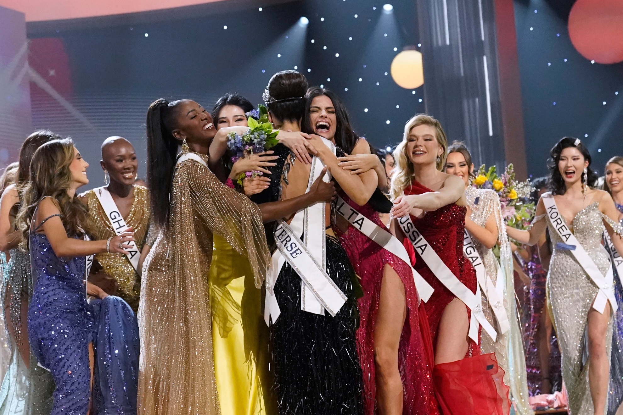 Miss Universe winner celebrating with her rivals.