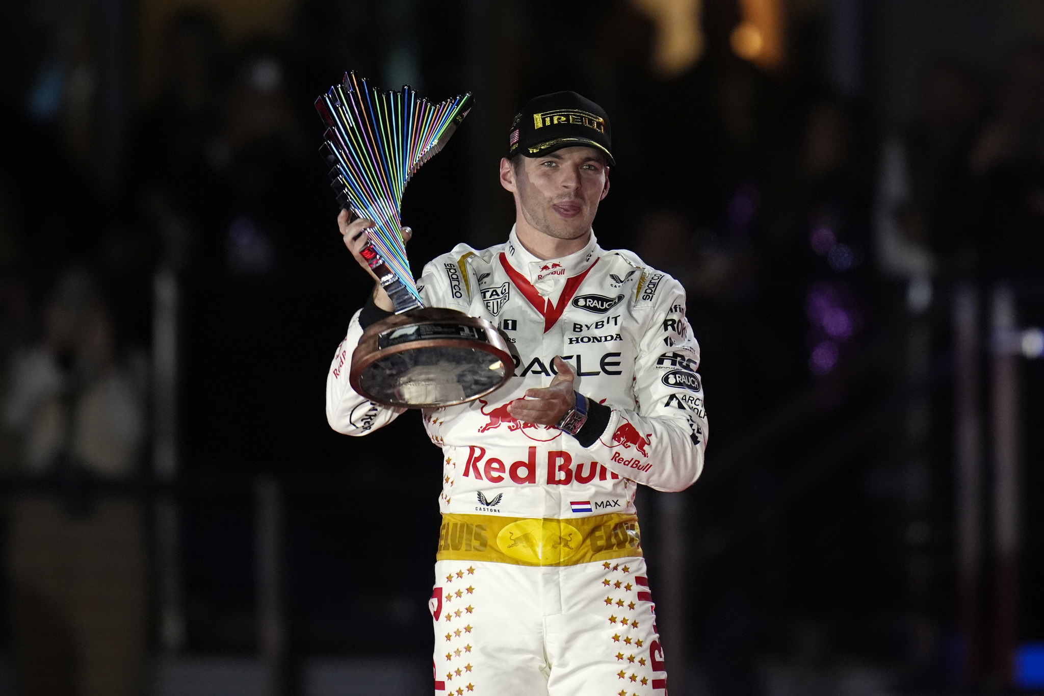 Red Bull driver Max Verstappen, of the Netherlands, holds a trophy after winning the Formula One Las Vegas Grand Prix.