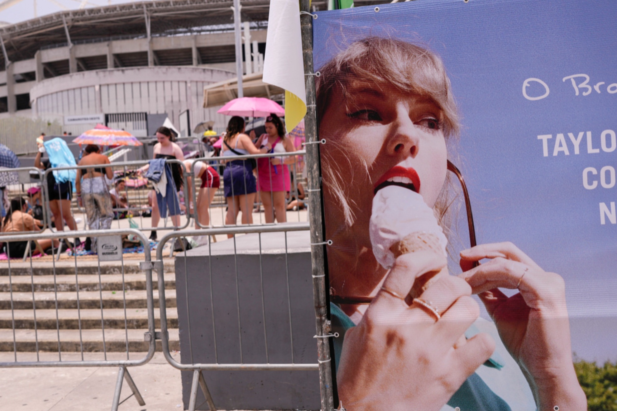 Fans take shelter from the high temperatures during Taylor Swift's concert in Brazil.