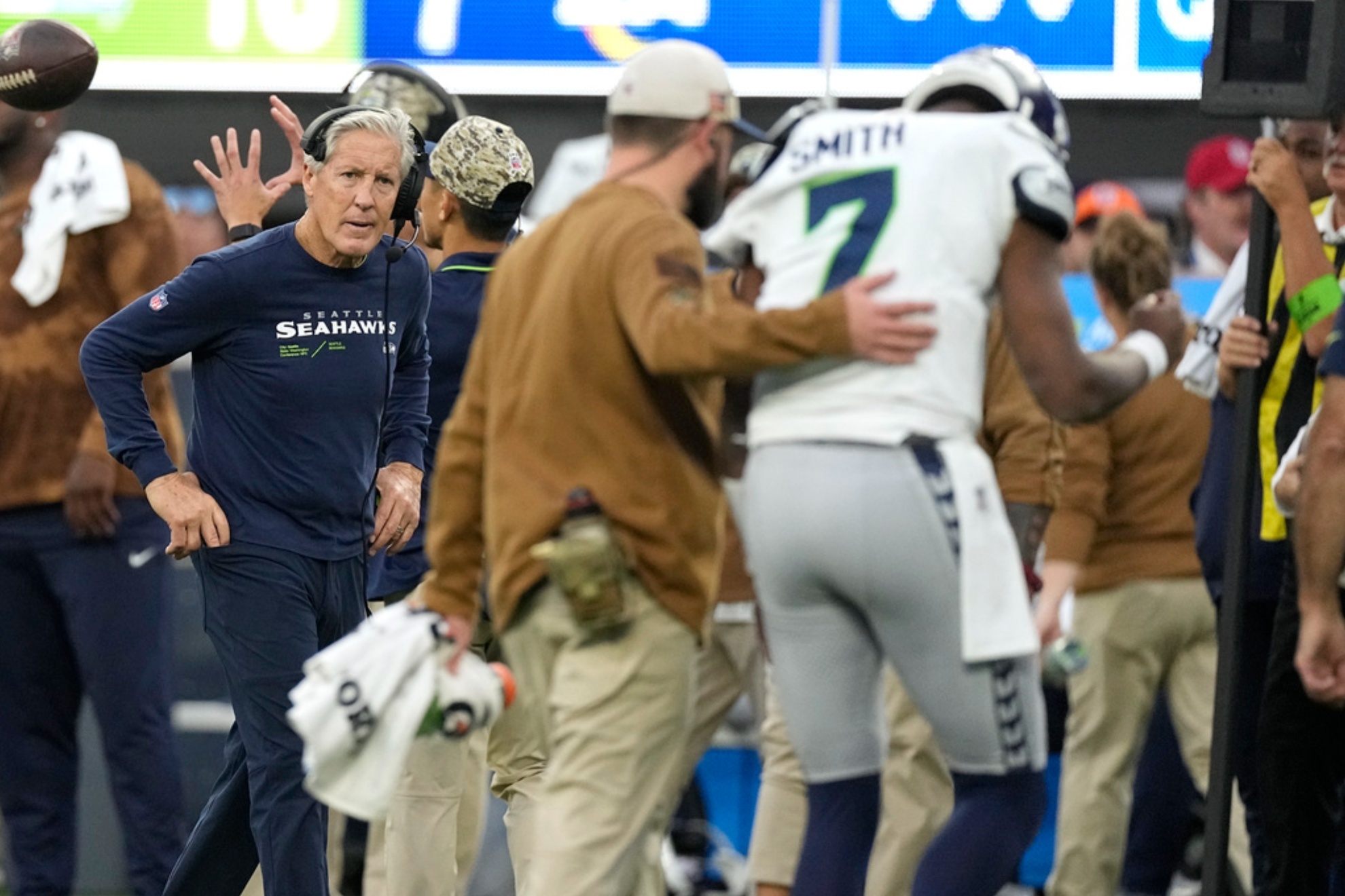 Pete Carroll watches worriedly as Geno Smith goes off injured.
