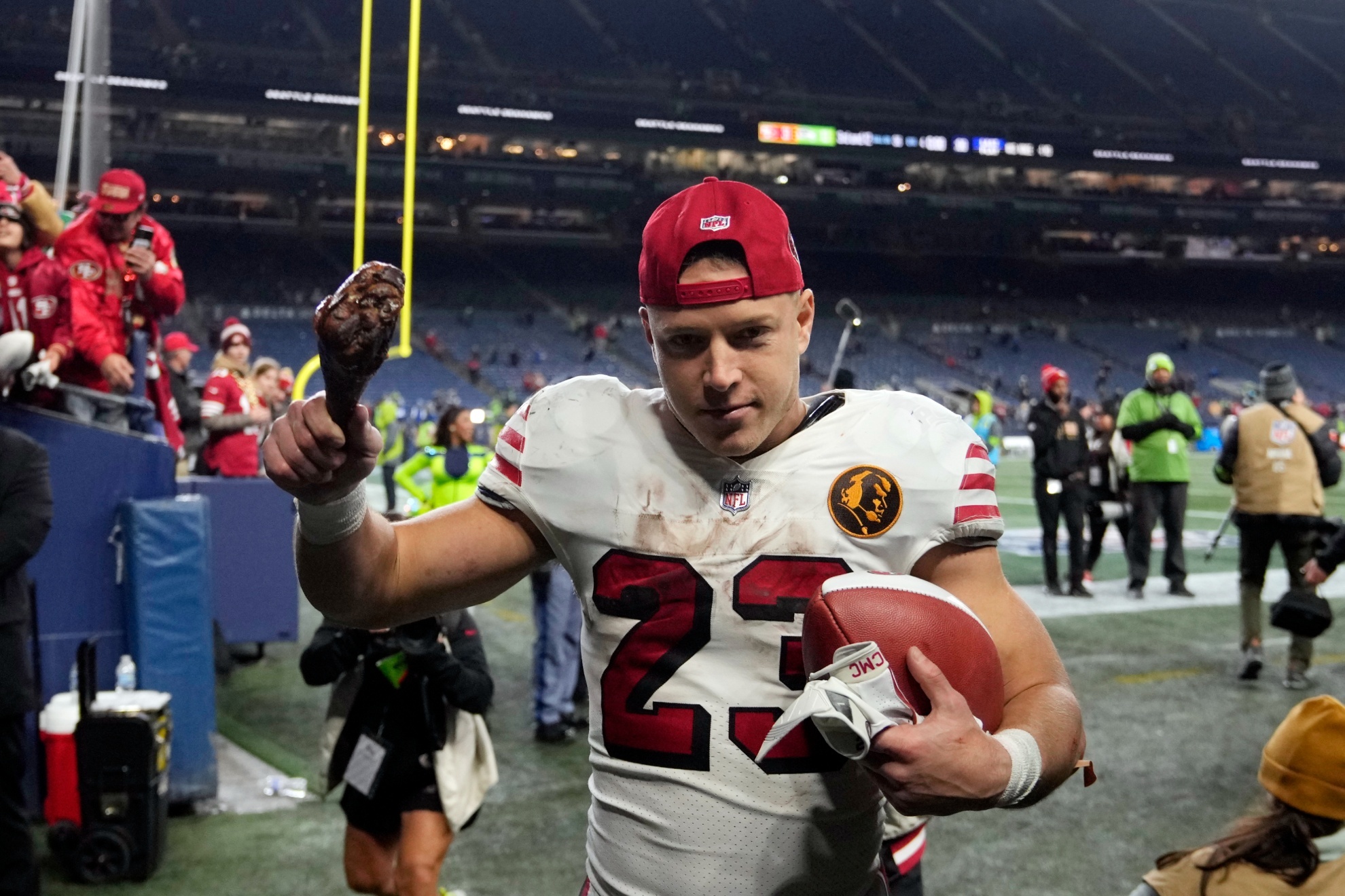 San Francisco 49ers running back Christian McCaffrey carries a turkey leg after an NFL football game against the Seattle Seahawks.