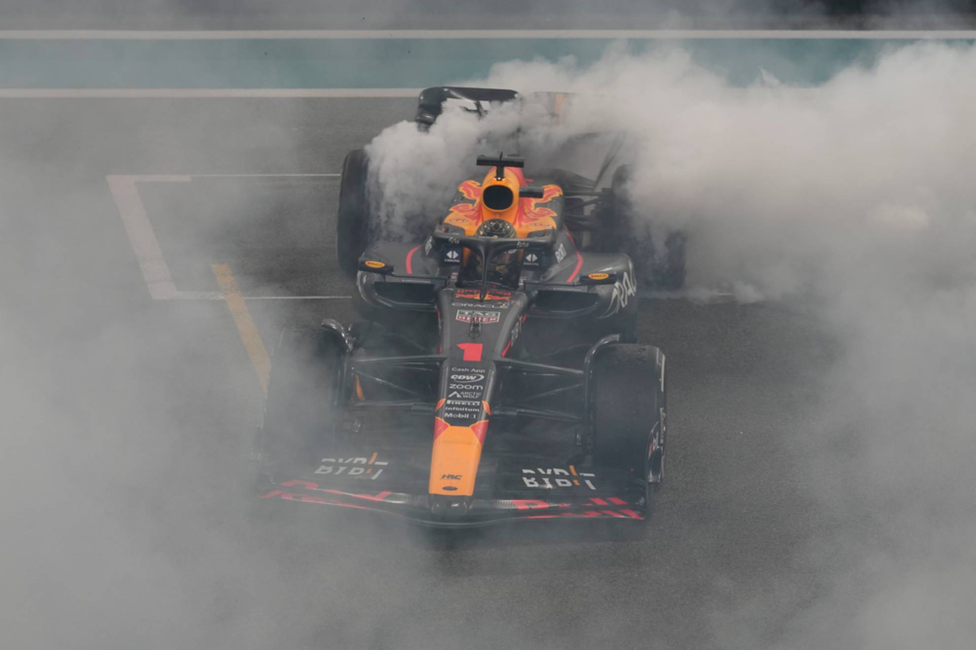 Max Verstappen spins in his car as he celebrates winning the Abu Dhabi Formula One GP