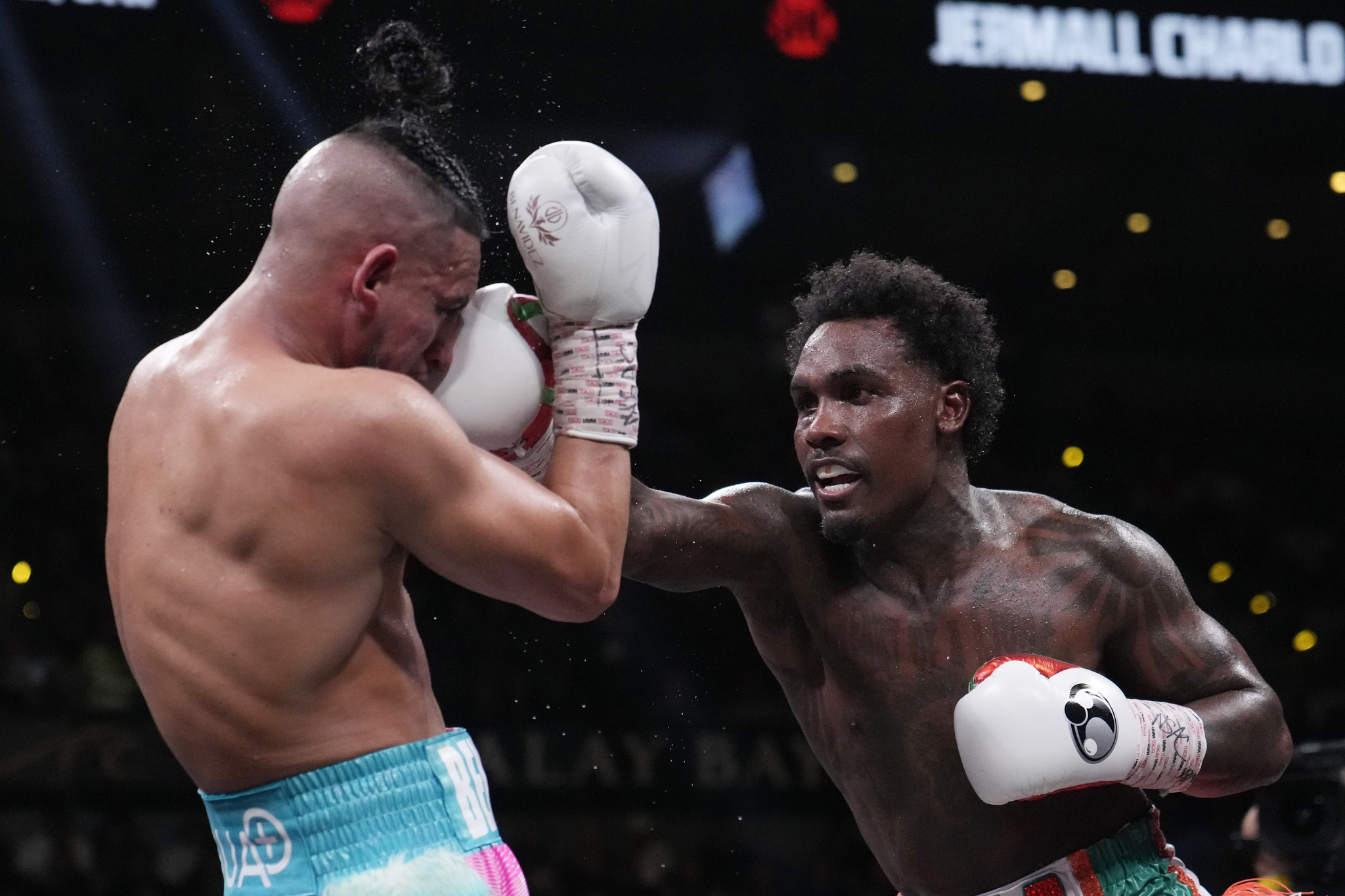 Jermall Charlo hits Jose Benavidez Jr. during a middleweight boxing match