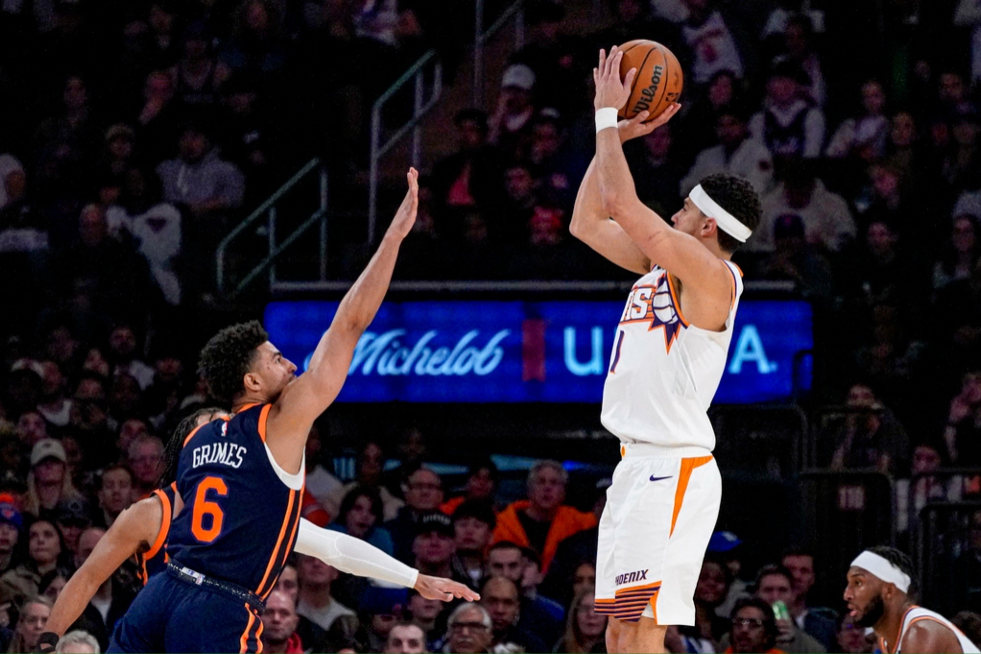 Devin Booker shooting over Knicks' Quentin Grimes.