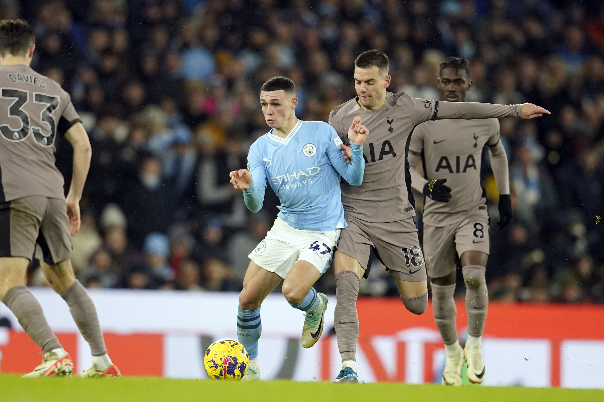 Tottenhams Giovani Lo Celso vies for the ball with Manchester Citys Phil Foden