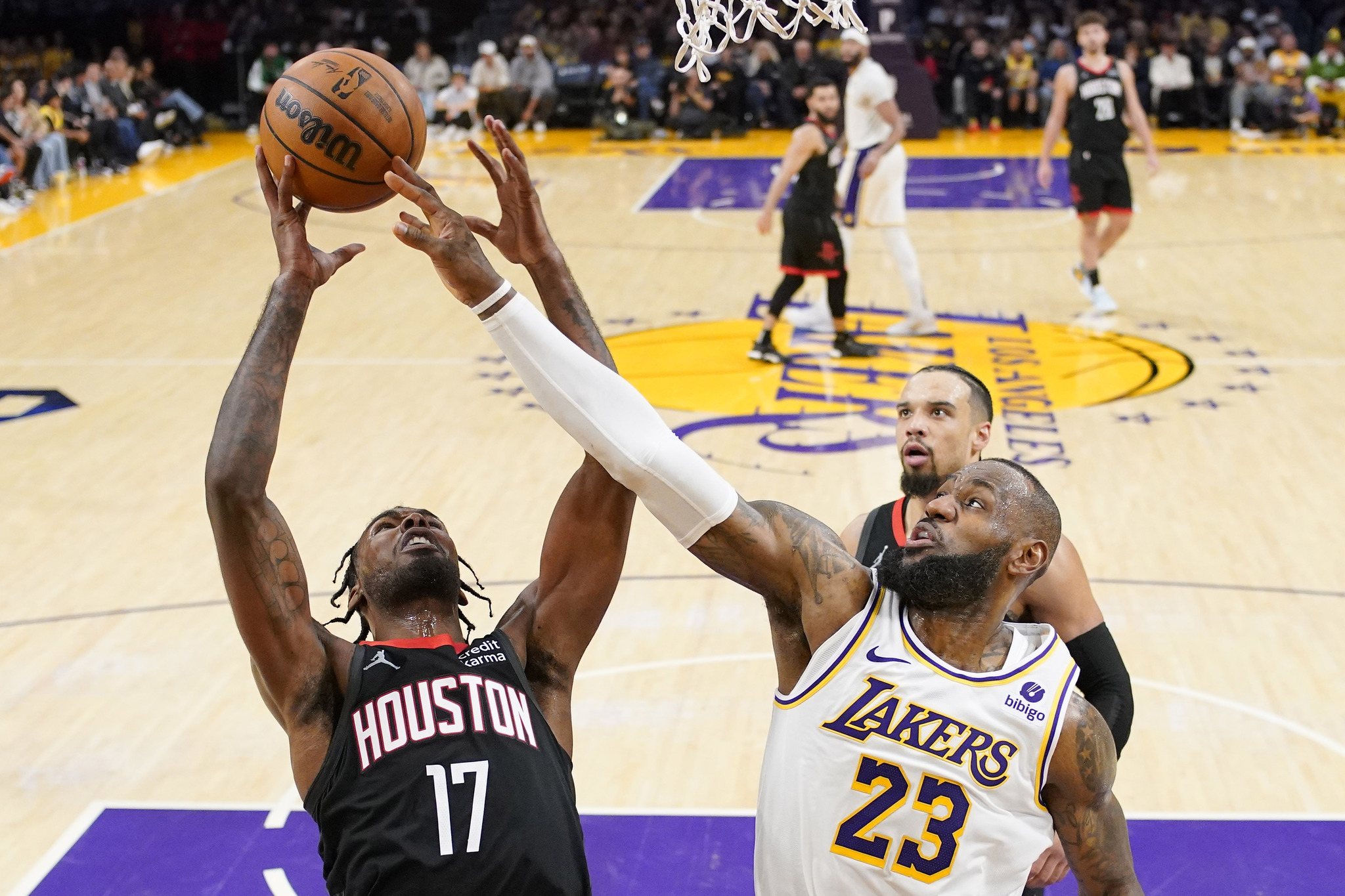 Houston Rockets forward Tari Eason, left, and Los Angeles Lakers forward LeBron James reach for a rebound