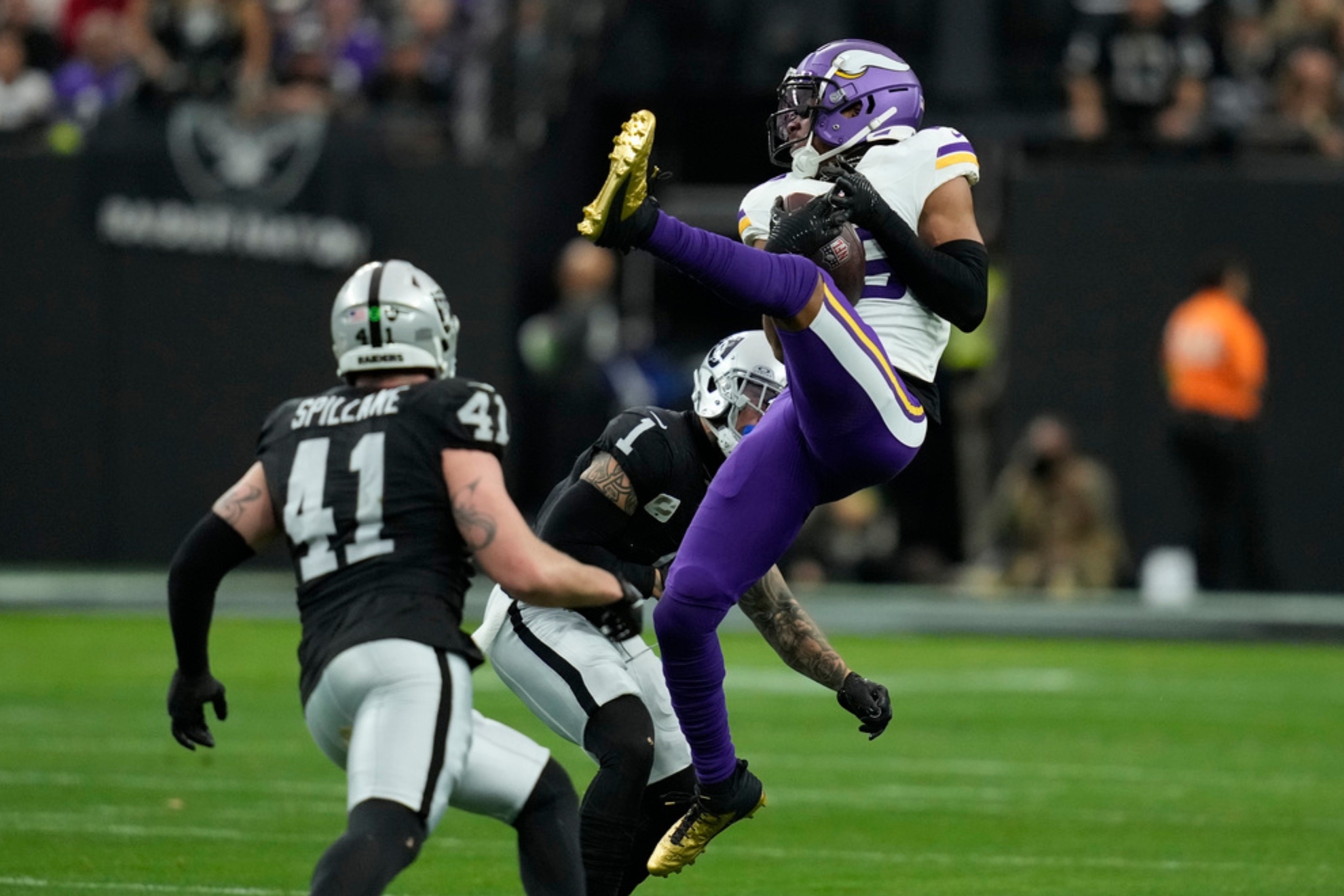 Minnesota Vikings wide receiver Justin Jefferson (18) makes a catch as Las Vegas Raiders safety Marcus Epps (1) defends during the first half of an NFL football game