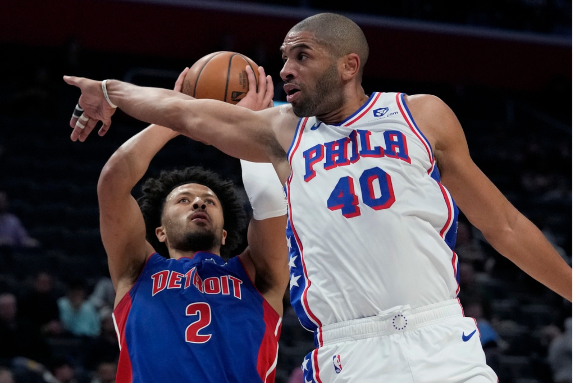 Detroit Pistons guard Cade Cunningham (2) shoots over the defense of Philadelphia 76ers forward Nicolas Batum (40) during the first half of an NBA basketball game, Wednesday, Dec. 13, 2023, in Detroit. (AP Photo/Carlos Osorio)