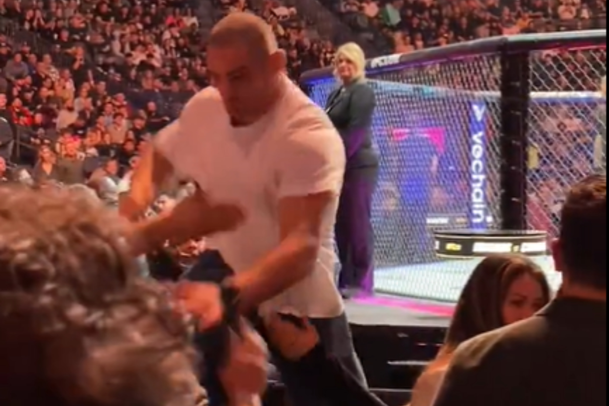 Sean Strickland jumps over audience seats to pummel Dricus Du Plessis during UFC 296