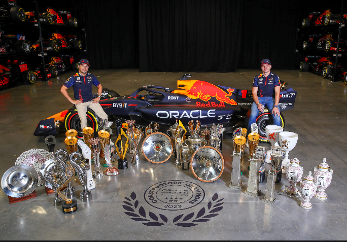 Max Verstappen and Checo Perez with the trophies of 2023.