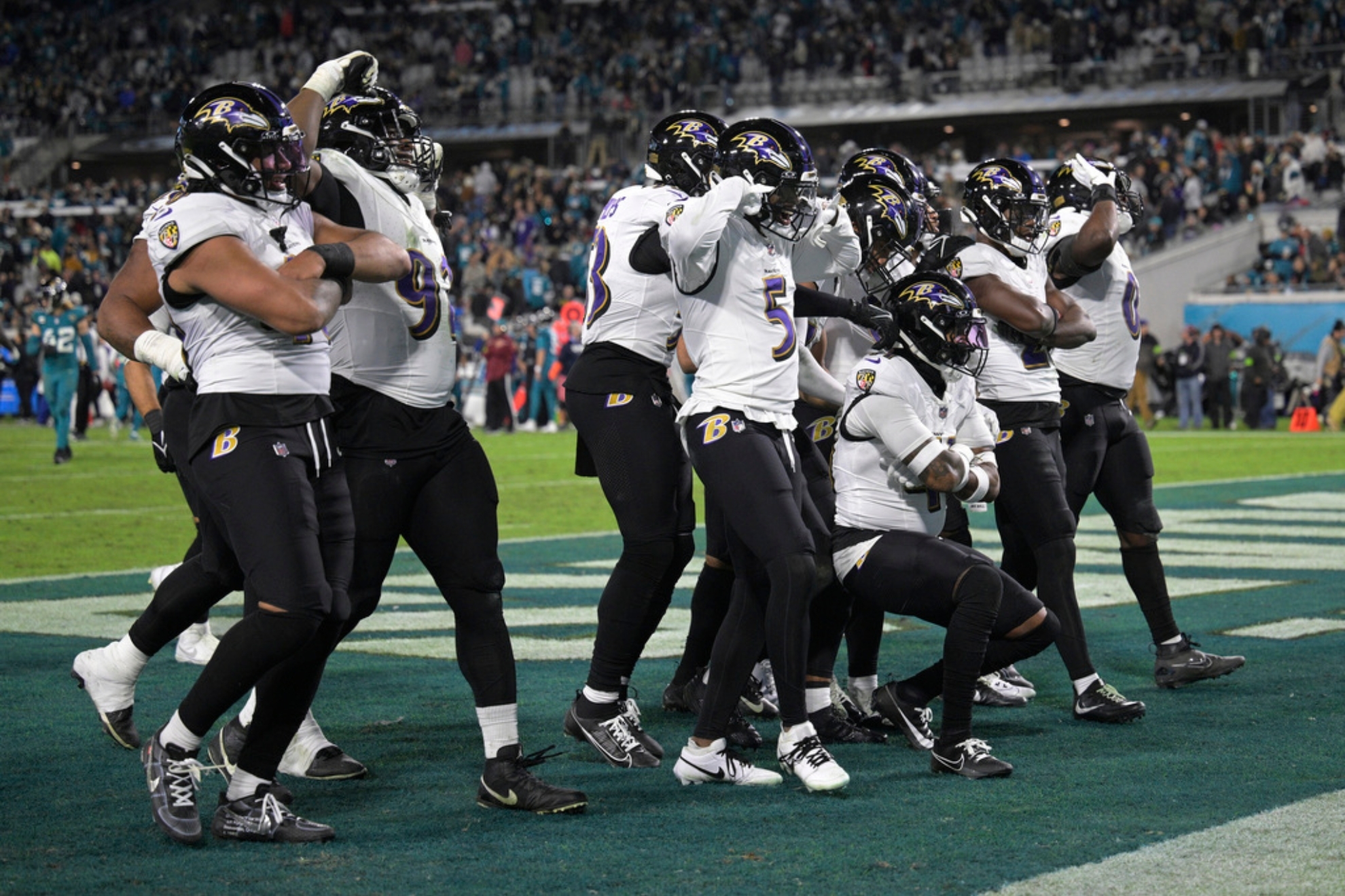 Baltimore Ravens defensive players celebrate after recovering a fumble by the Jacksonville Jaguars in the second half of an NFL football game Sunday, Dec. 17, 2023, in Jacksonville, Fla. (AP Photo/Phelan M. Ebenhack)