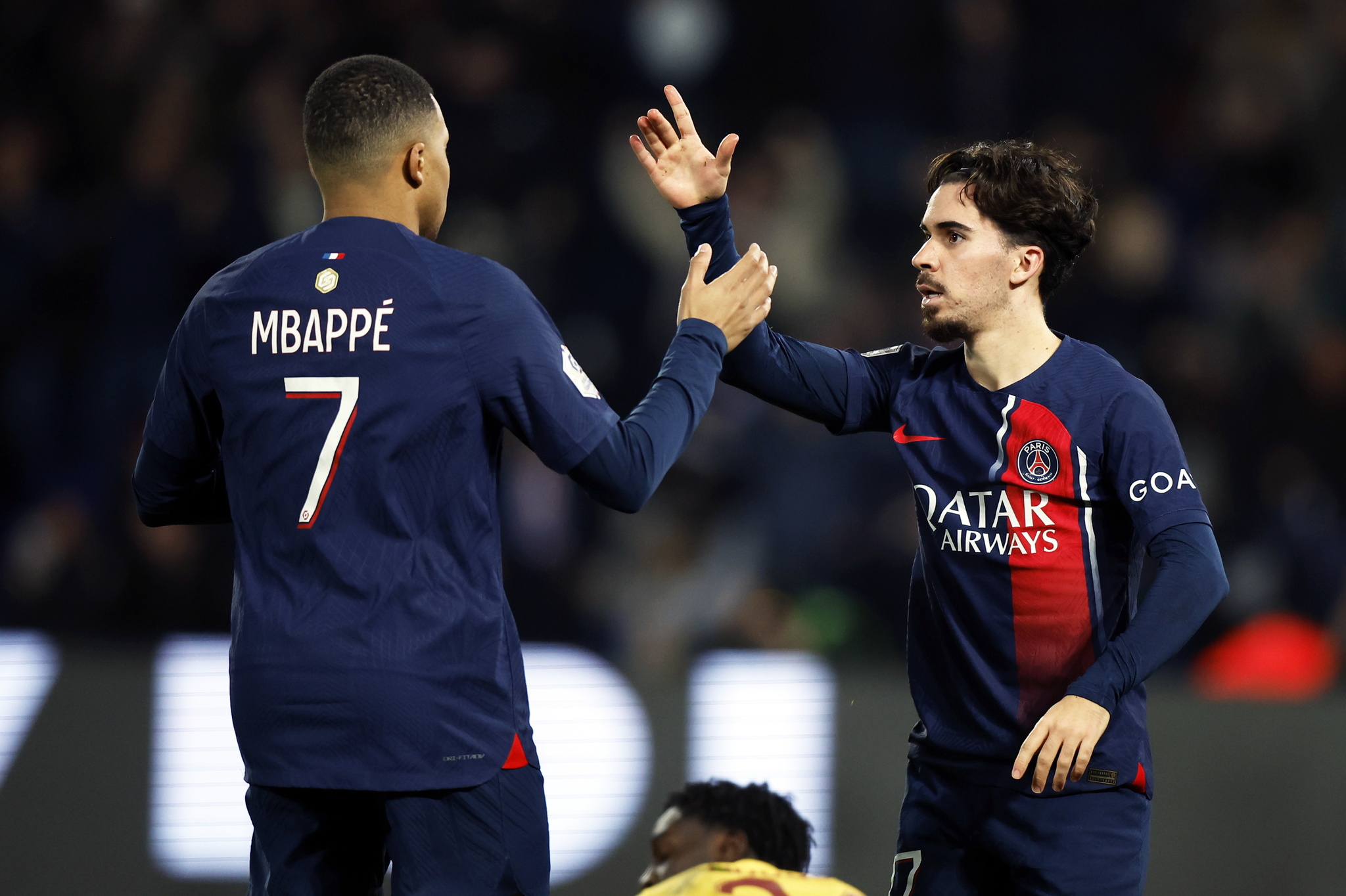 Paris Saint Germains Vitinha celebrates with Kylian Mbappe (L) after scoring