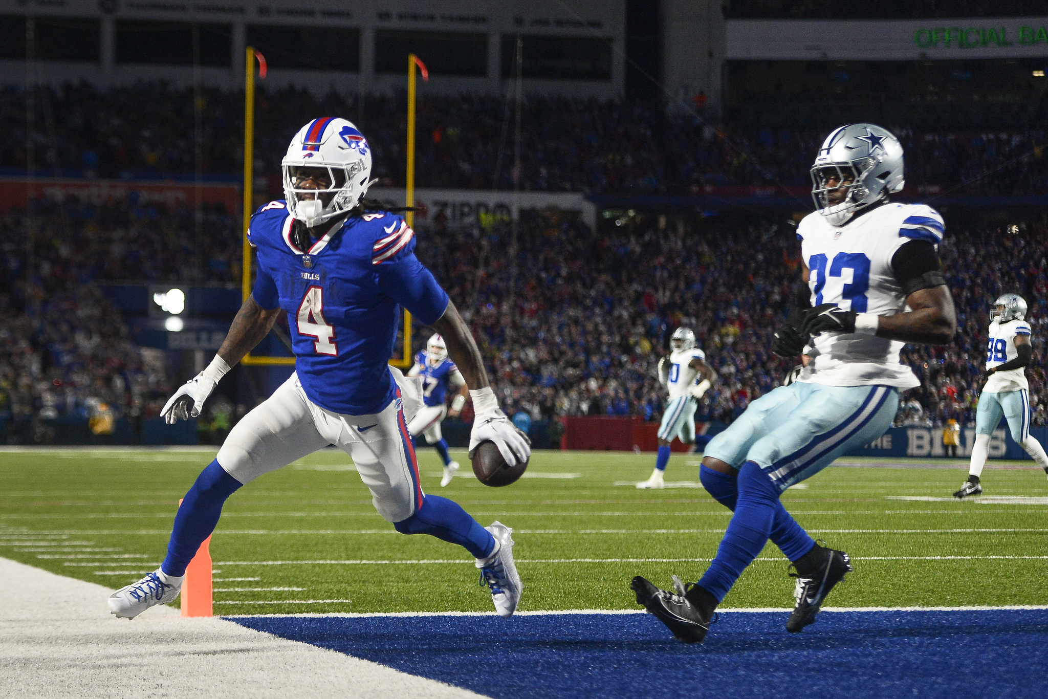 Buffalo Bills running back James Cook (4) comes up with a touchdown catch against Dallas Cowboys linebacker Damone Clark (33) during the second quarter of an NFL football game, Sunday, Dec. 17, 2023, in Orchard Park, N.Y. (AP Photo/Adrian Kraus)