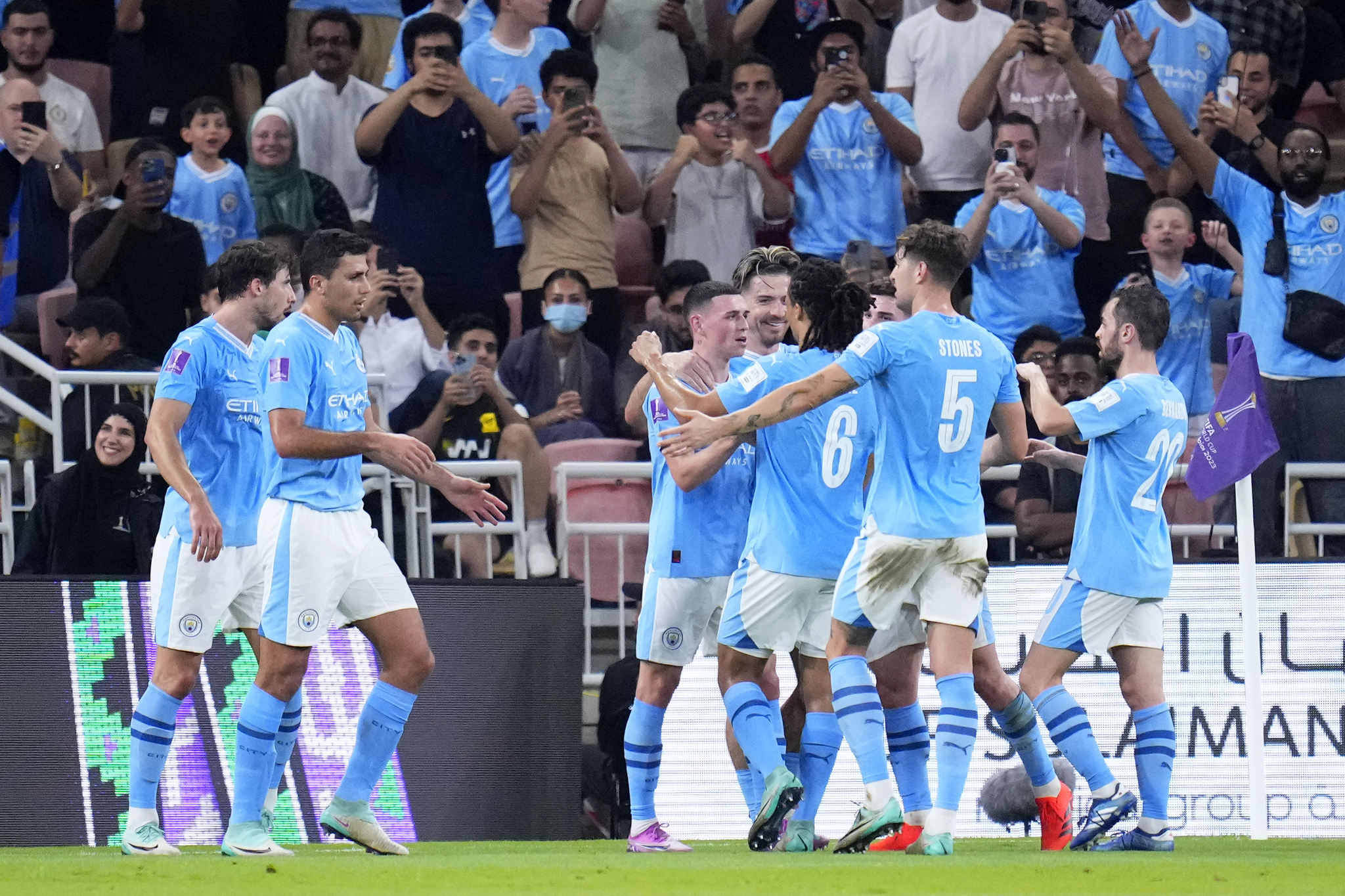 Manchester City players celebrate after scoring their second goal