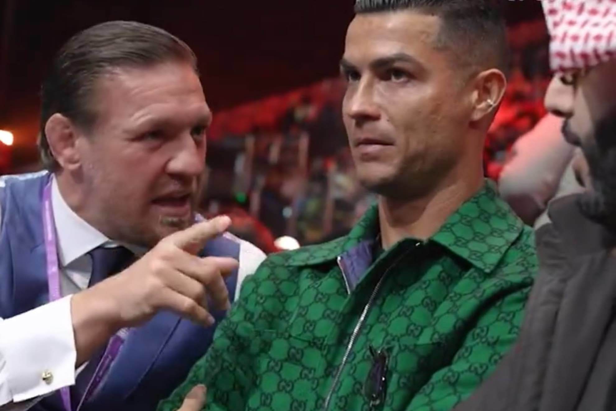 Conor McGregor tries to talk to Cristiano Ronaldo ringside in Riyadh