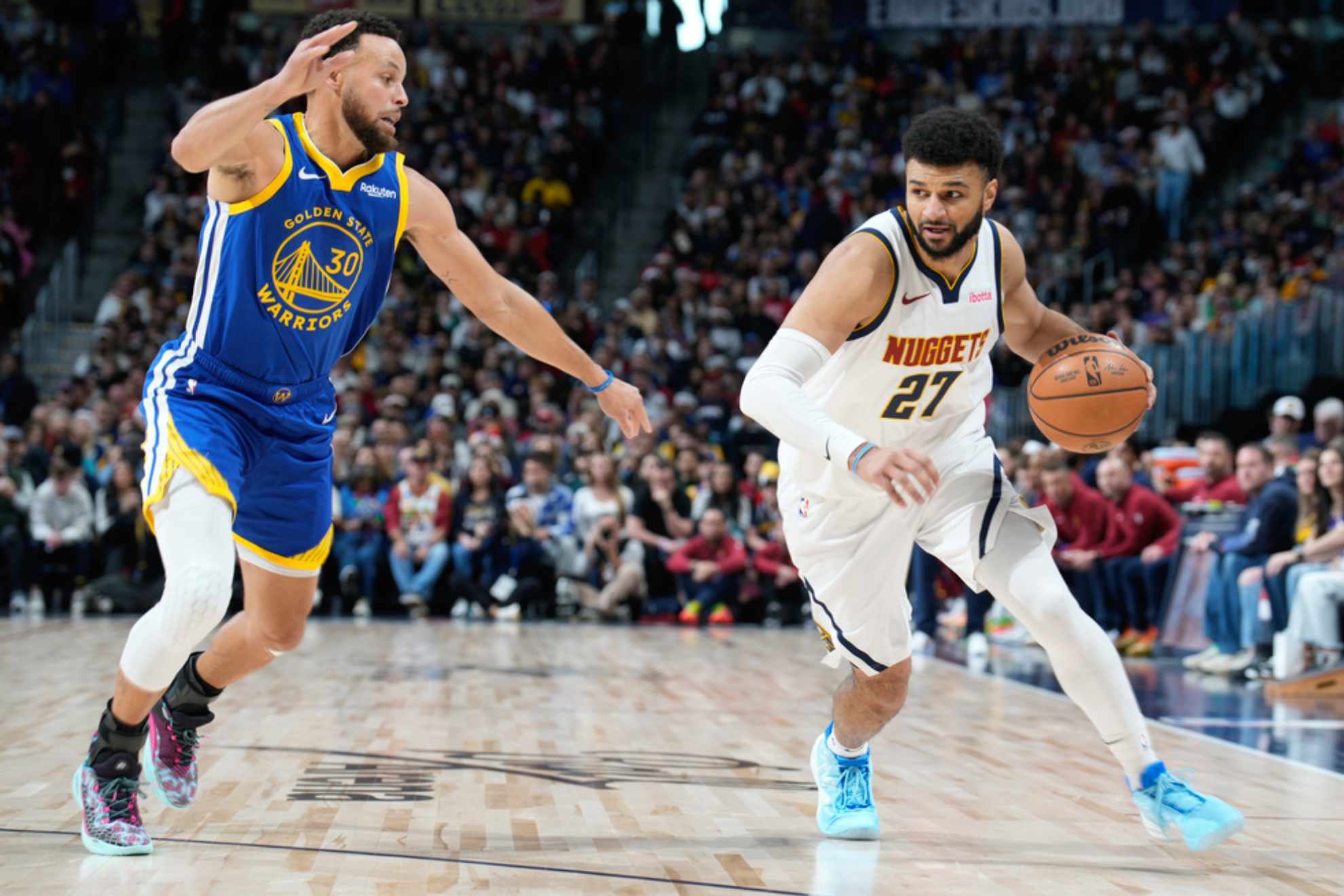 Denver Nuggets guard Jamal Murray, right, drives past Golden State Warriors guard Stephen Curry /