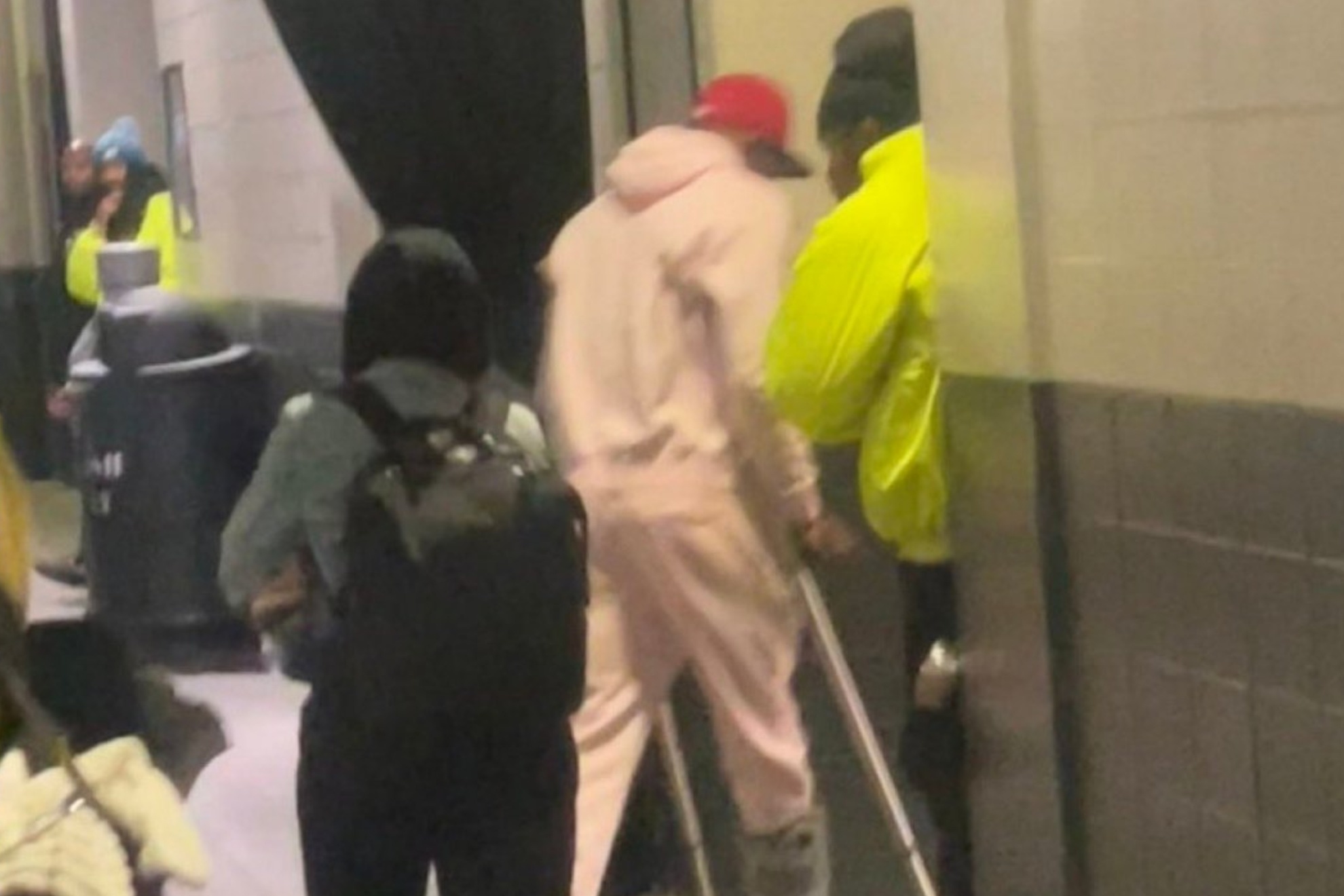 DeVonta Smith leaving the Lincoln Financial Field using walking aides.