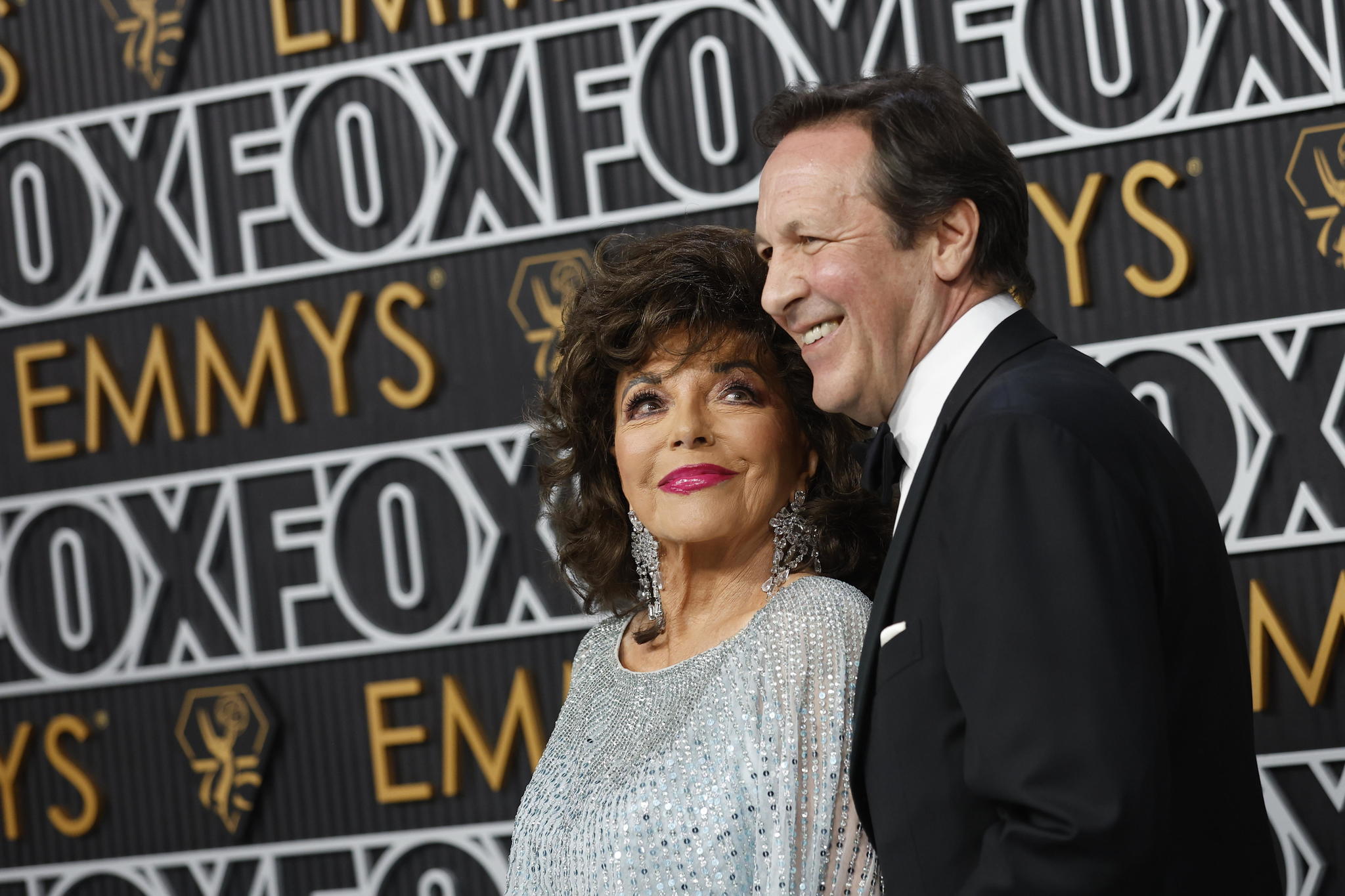 Joan Collins and Percy Gibson arrive for the 75th annual Primetime Emmy Awards ceremony held at the Peacock Theater in Los Angeles, California, USA, 15 January 2024.