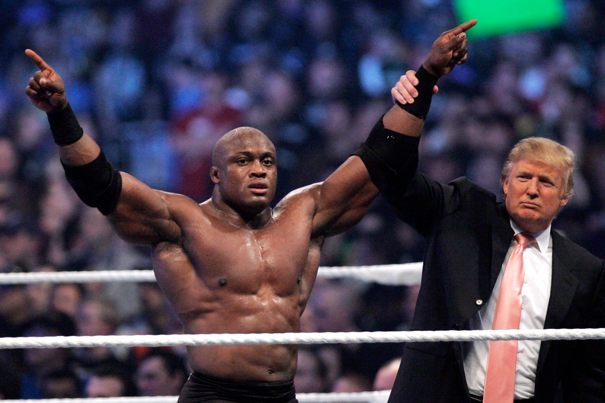 Donald Trump raises the arm of wrestler Bobby Lashley at Ford Field in Detroit, 2007.