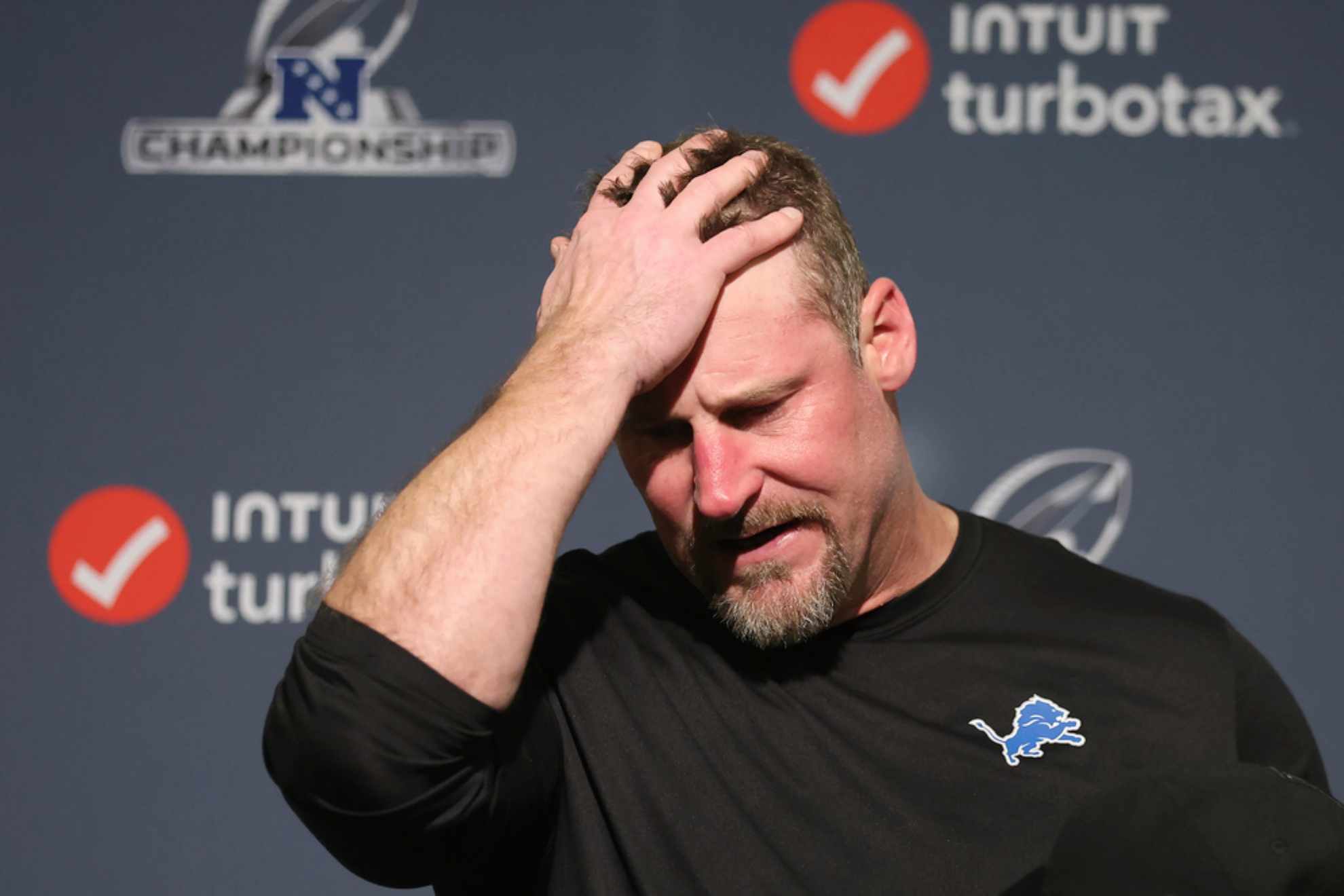 Dan Campbell reacts while speaking at a news conference after the NFC Championship /
