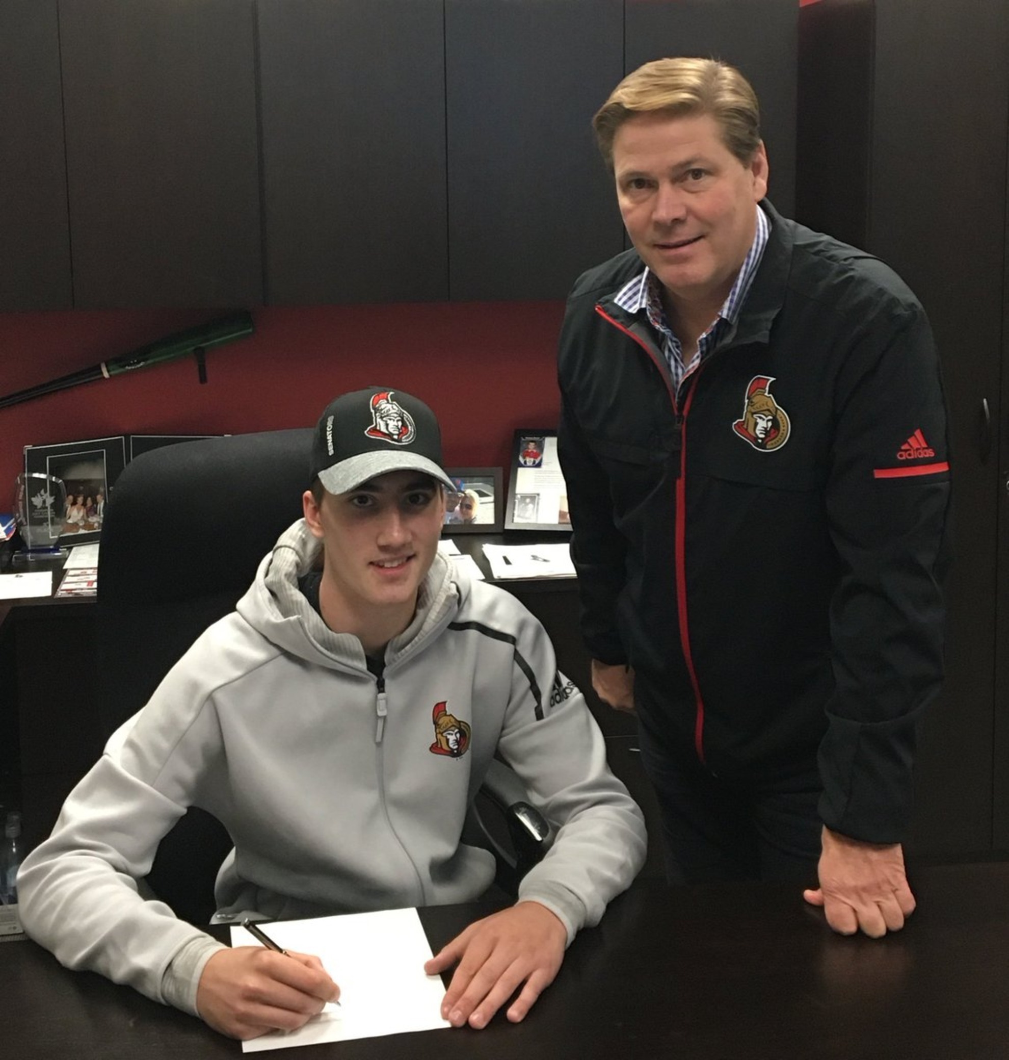 Alex Formenton while signing his first contract with the Ottawa Senators