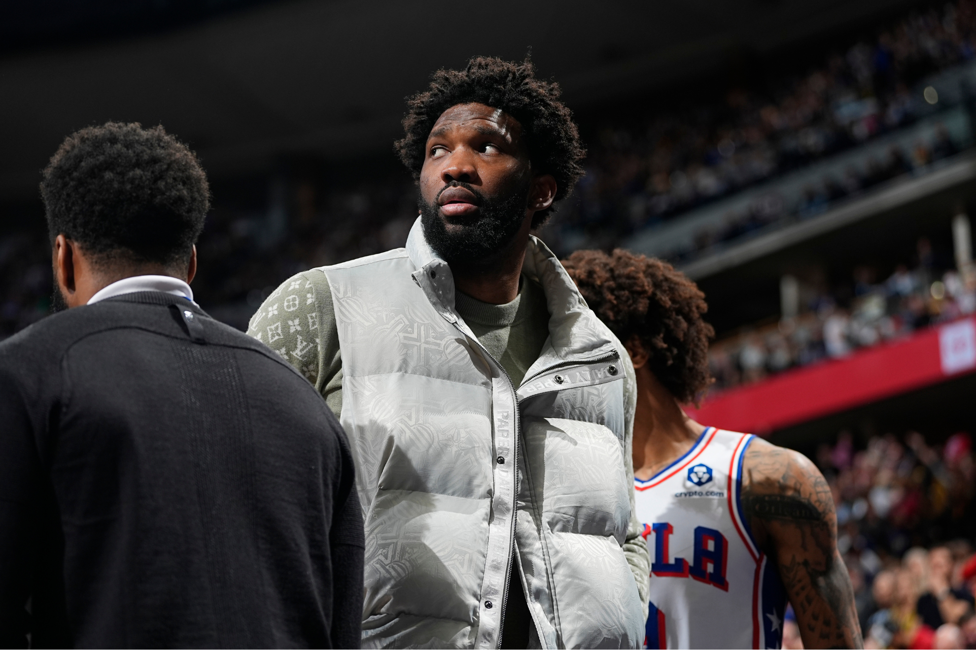 Joel Embiid on the sidelines during a Sixers game.