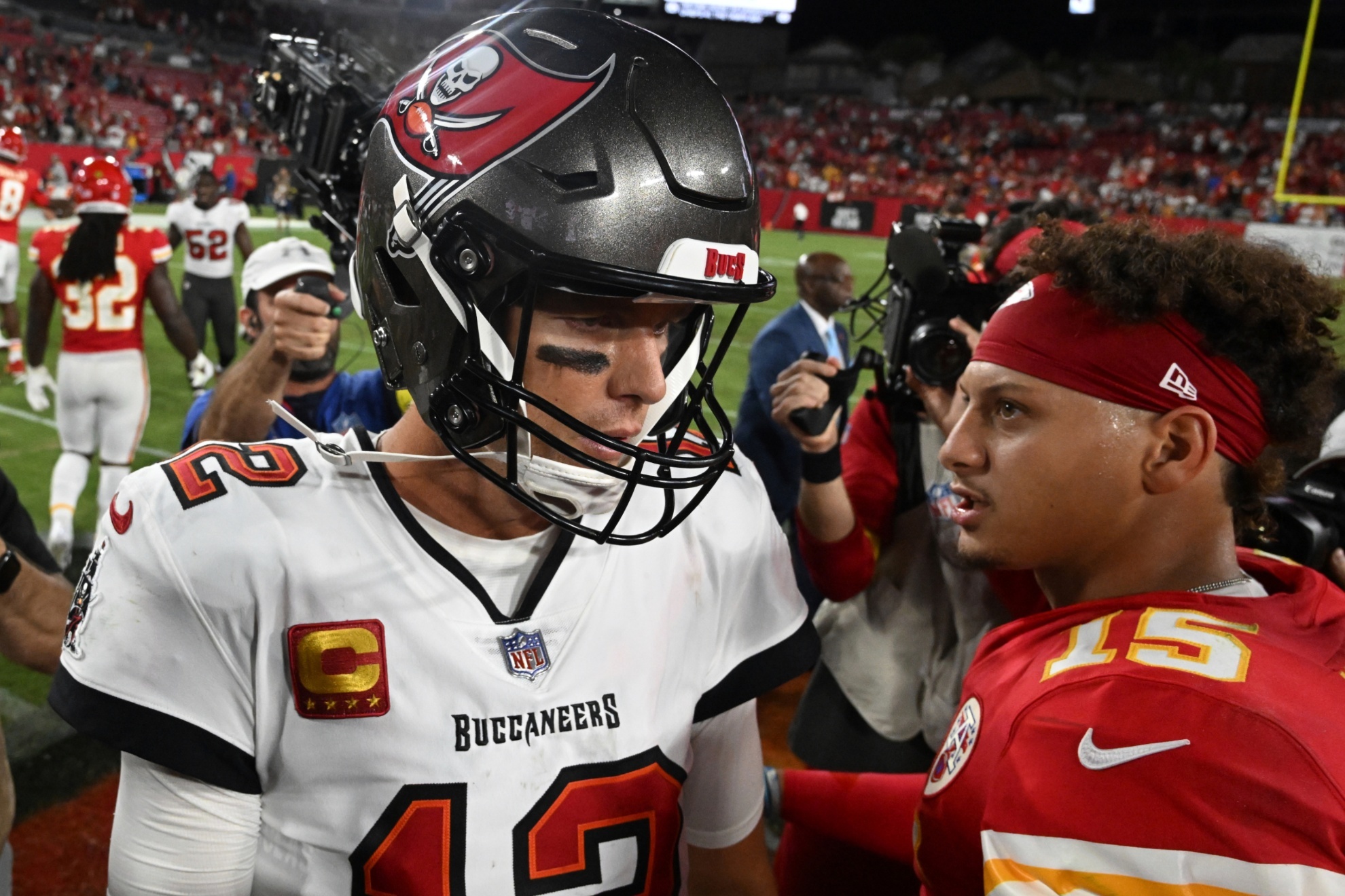 Tom Brady (L) and Patrick Mahomes greet each other after an NFL football game in 2022.