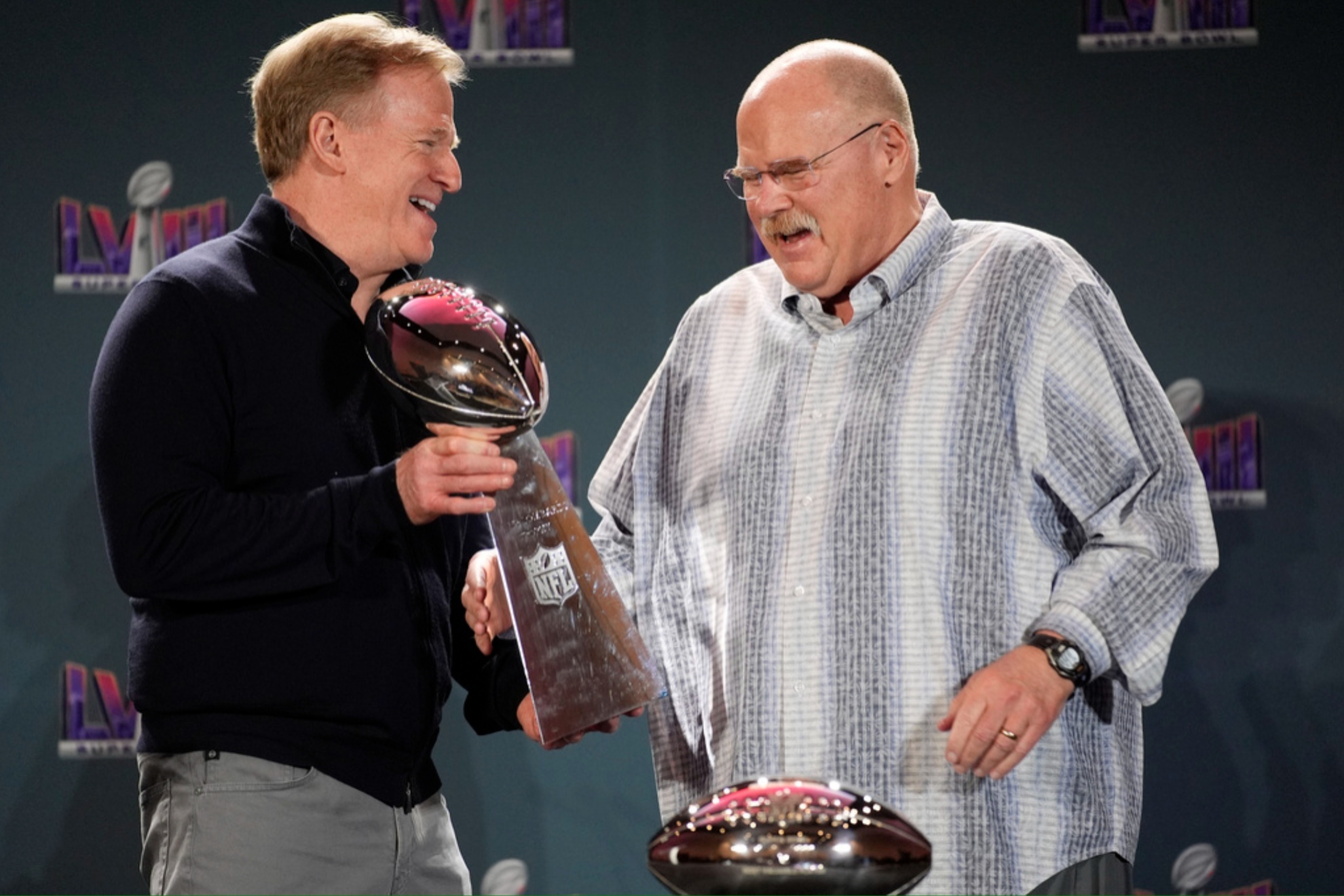 NFL Commissioner Roger Goodell (L) handles Andy Reid the Vince Lombardi Trophy.