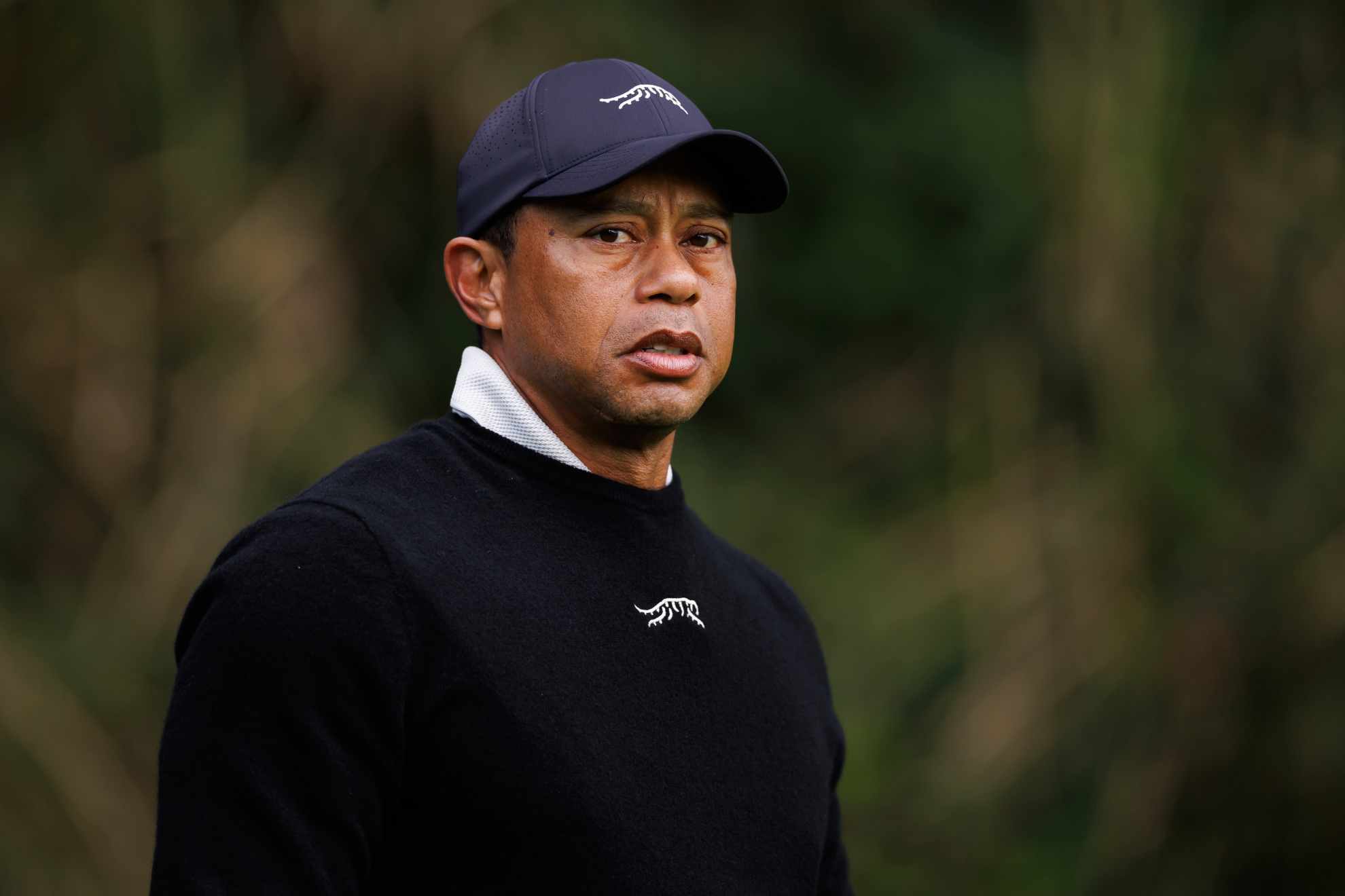 Tiger Woods looks on after his tee shot on the sixth hole during the Genesis Invitational pro-am golf event /