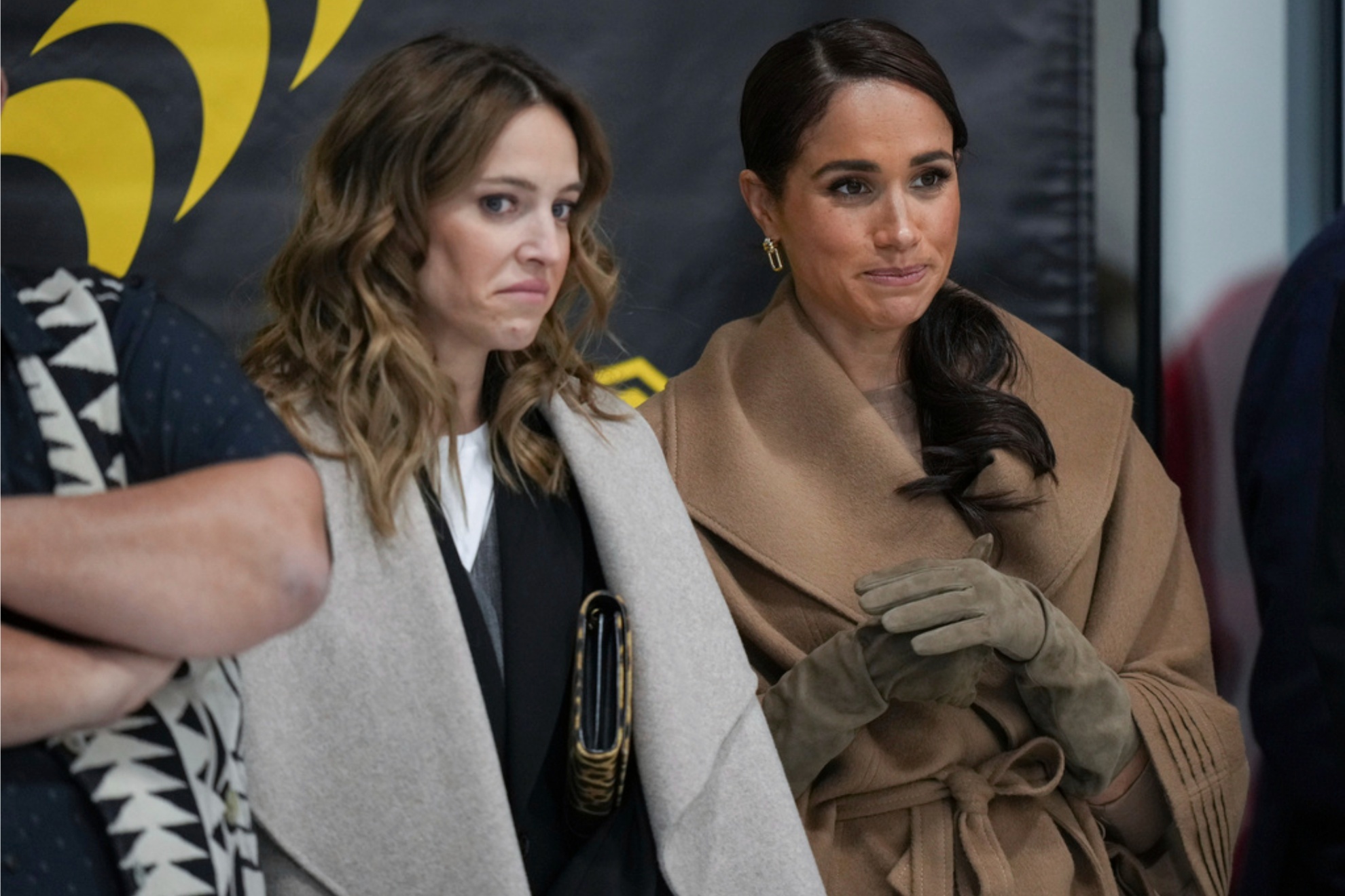 Meghan Markle (L) wearing the controversial outfit next to Louisiana Lopilato.