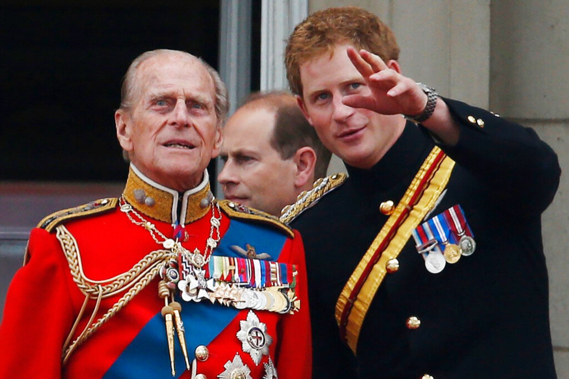Prince Harry talks to Prince Philip as members of the Royal family  on the balcony of Buckingham Palace