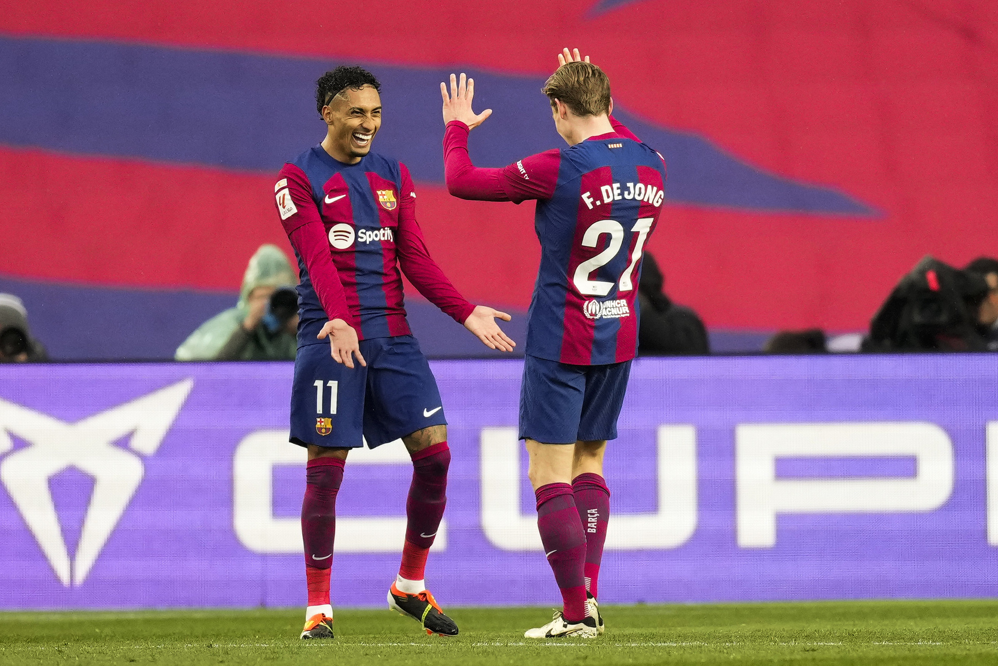 Frenkie De Jong celebrates with Raphinha after scoring Barcelonas third