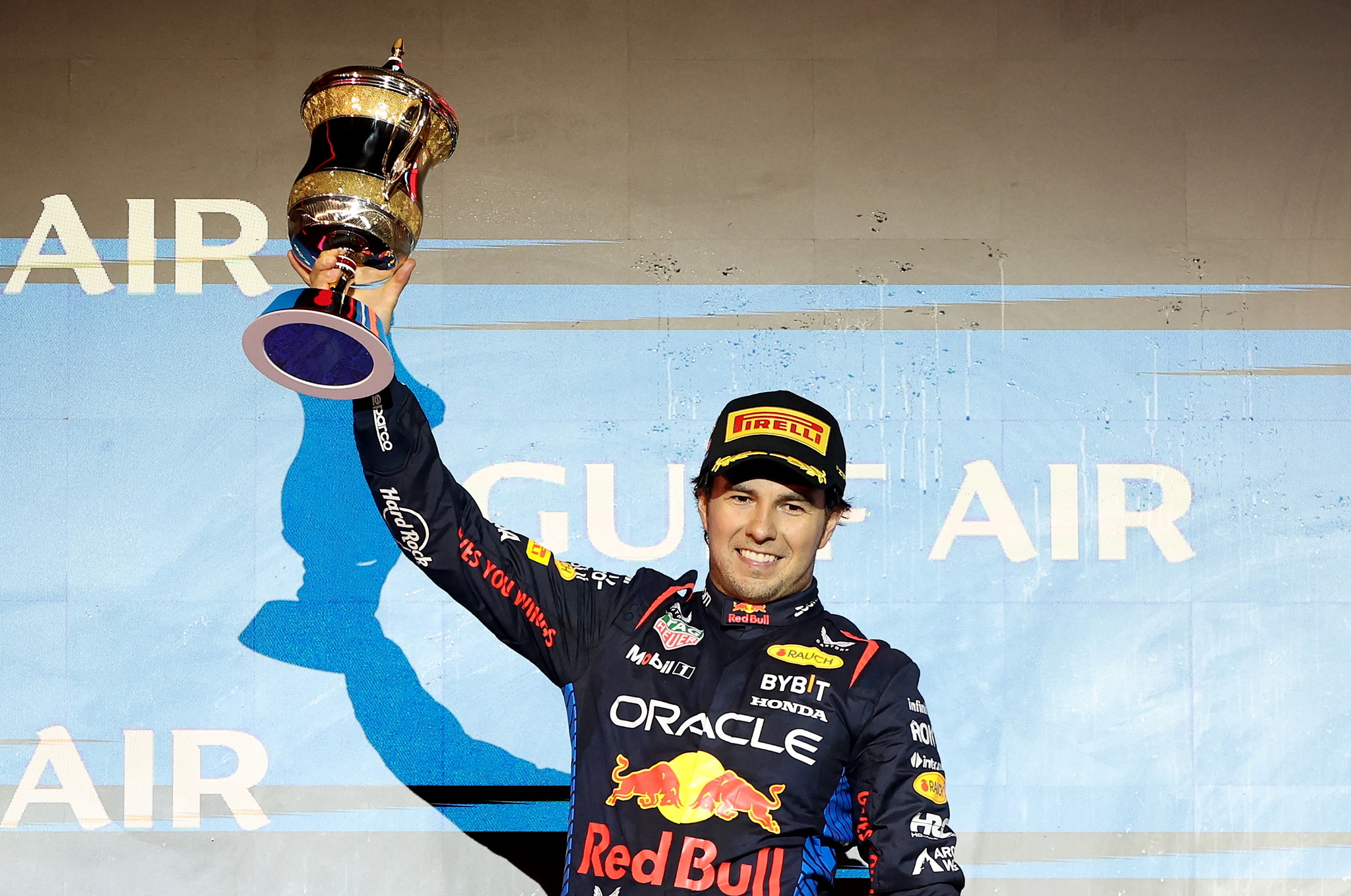 Sergio Perez lifts his trophy on the podium