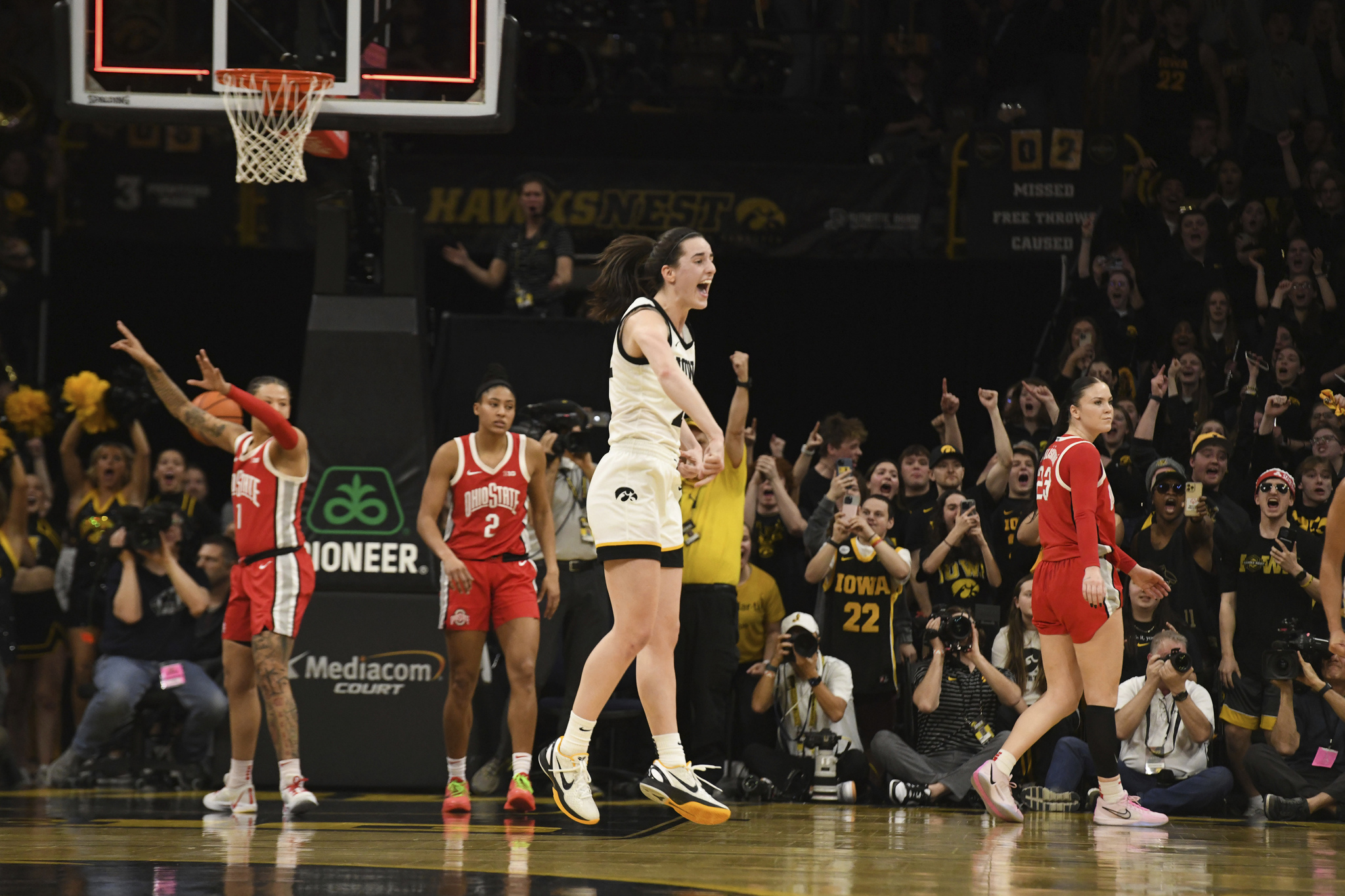 Caitlin Clark celebrates after becoming the all-time leading scorer in NCAA Division I basketball