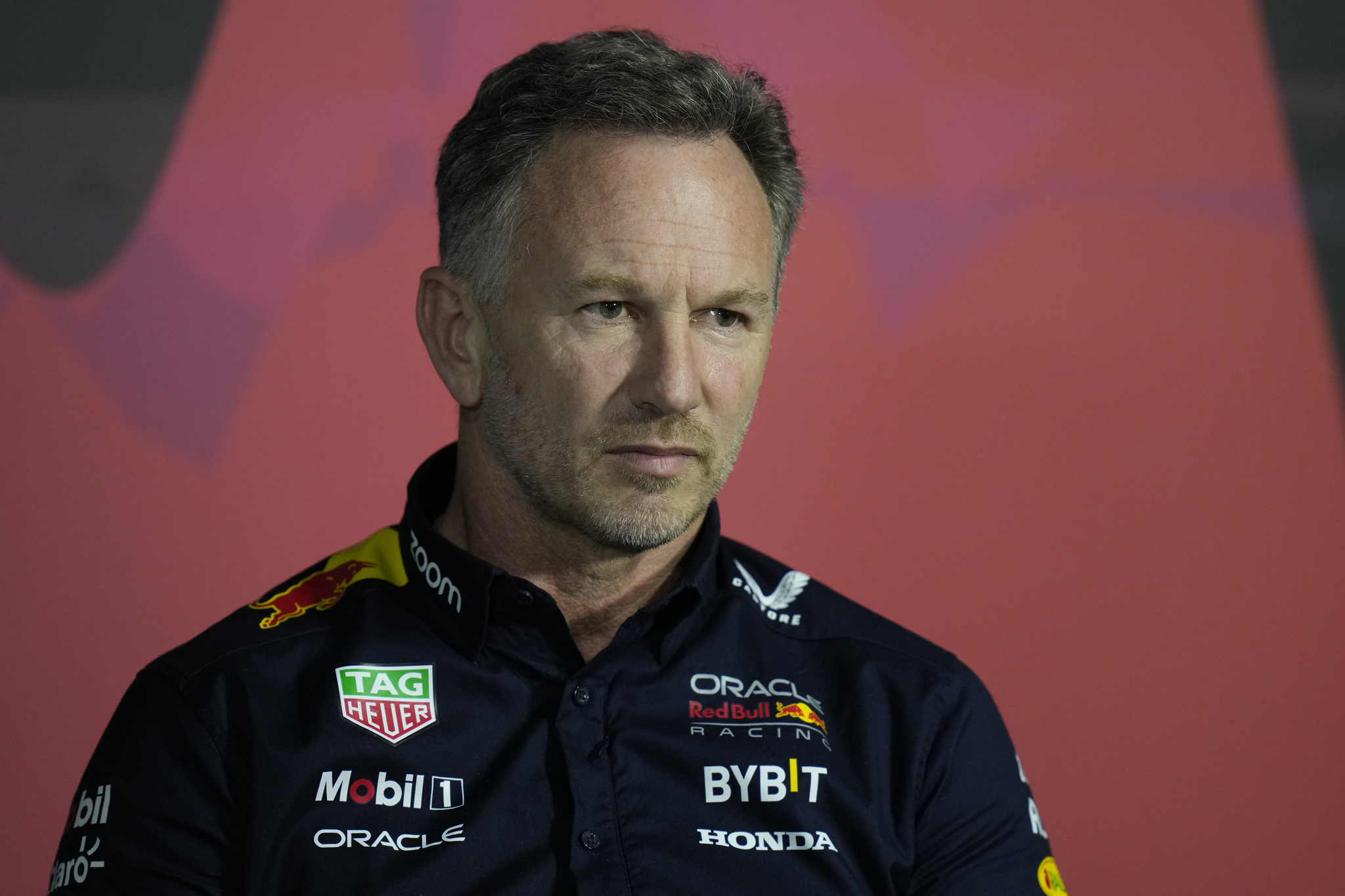 Red Bull team principal Christian Horner listens to a question during a press conference