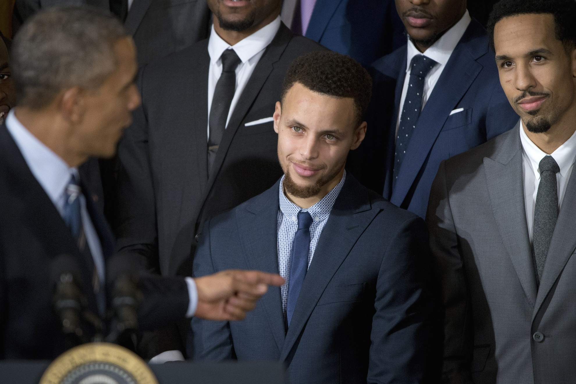 Stephen Curry looks at President Barack Obama