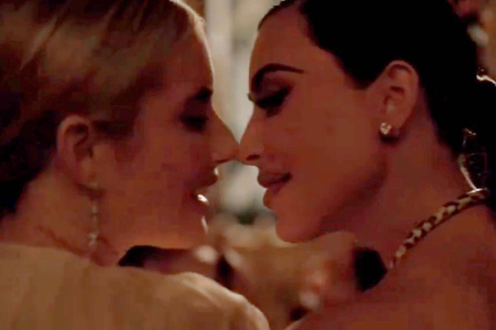 Kim Kardashian and Emma Roberts share a kiss