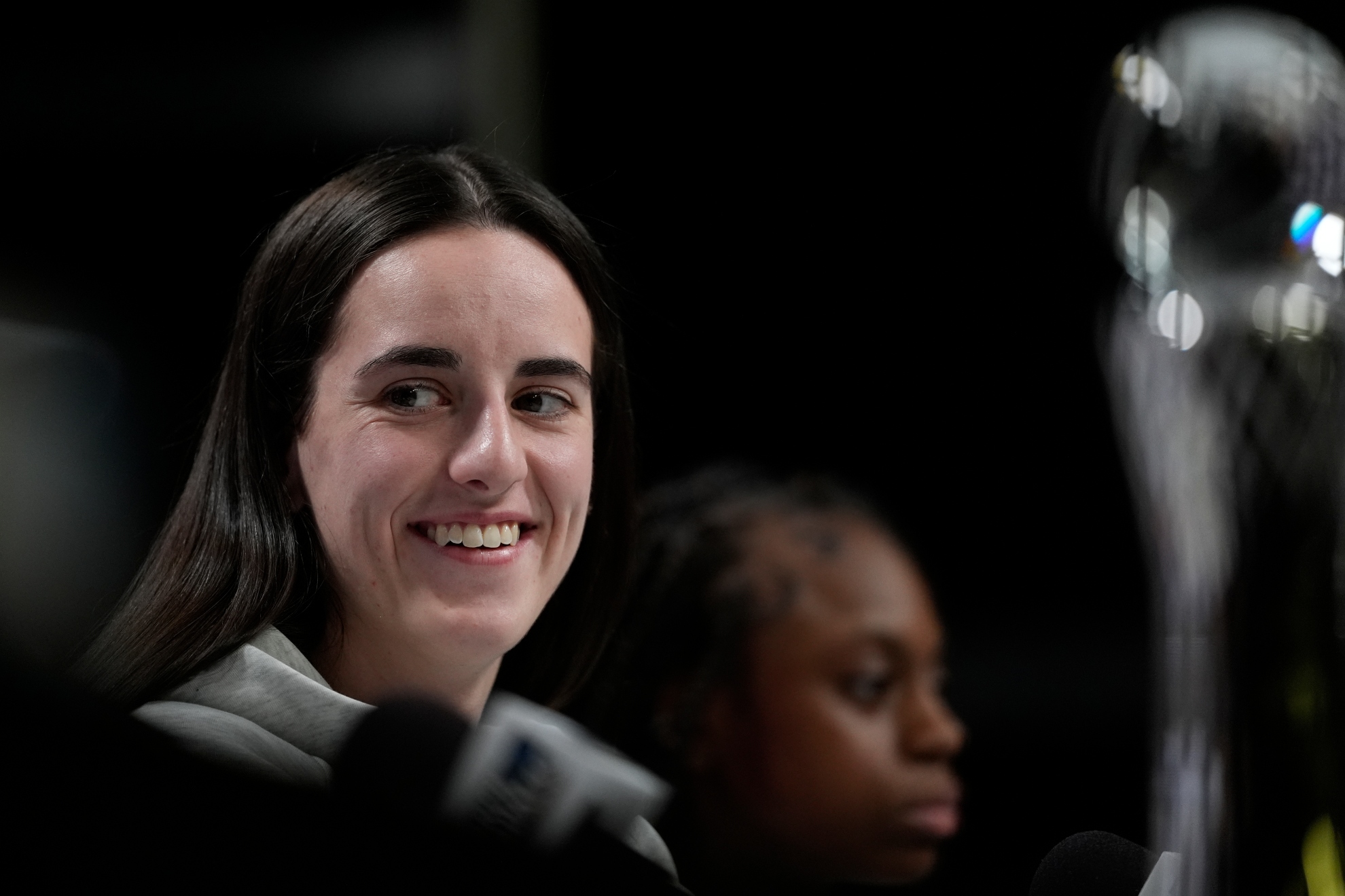 Iowas Caitlin Clark smiles during a news conference announcing the AP NCAA Womens Coach and Player of the Year Thursday, April 4, 2024, in Cleveland.