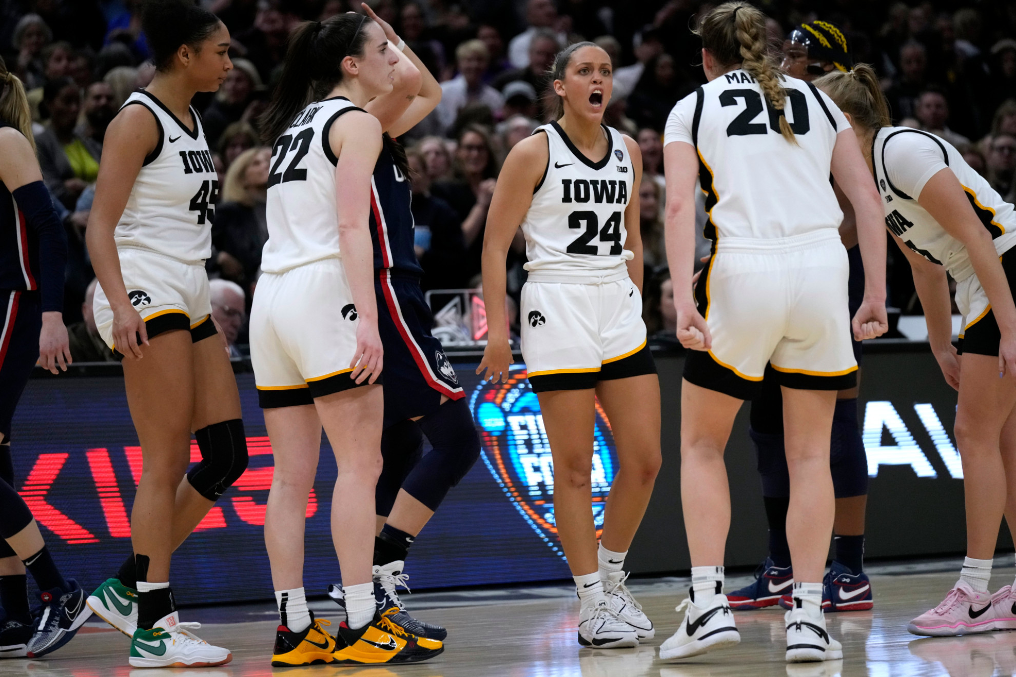 Iowa guard Gabbie Marshall celebrates with teammates during the second half of a Final Four college basketball game against UConn